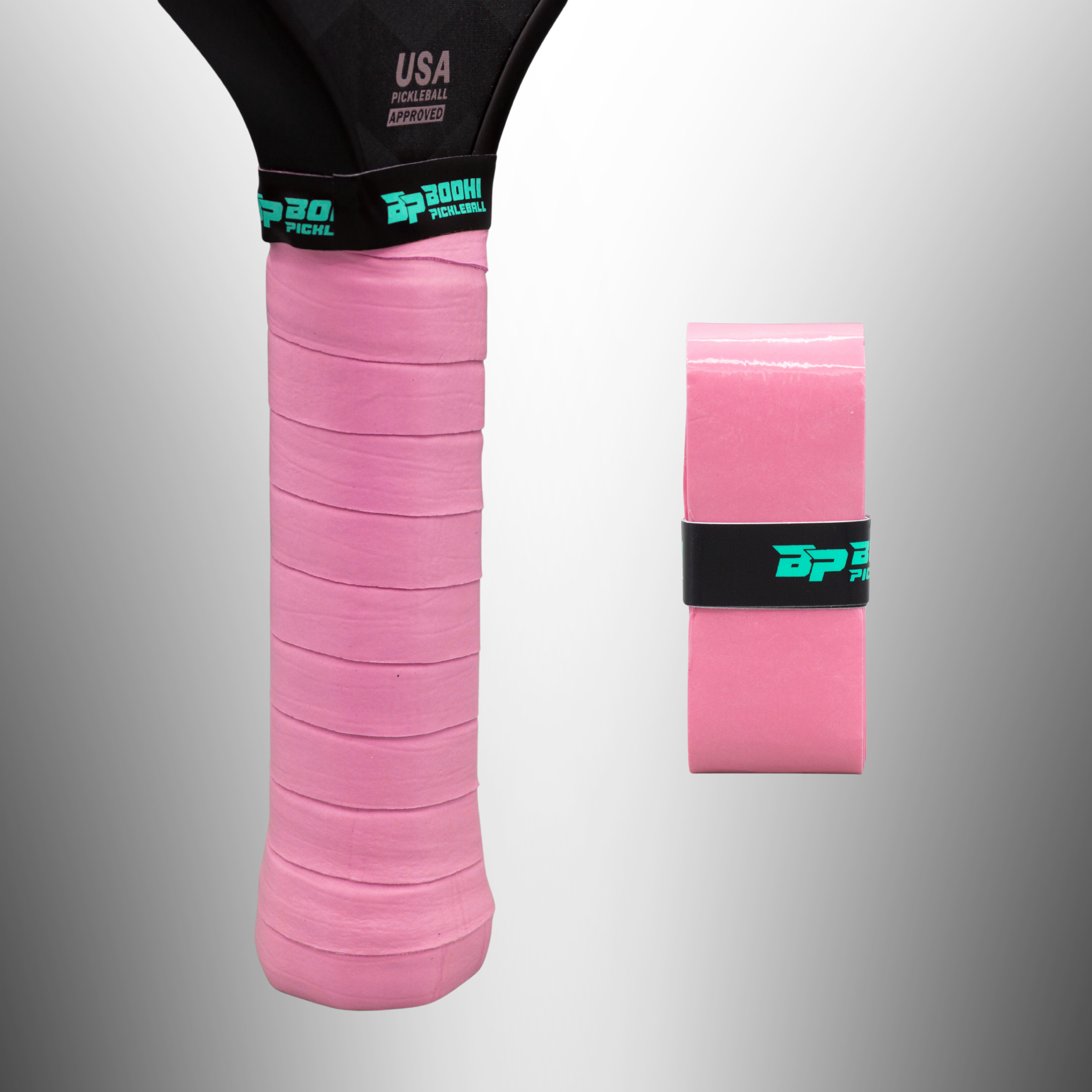 Pink PROtack overgrip by Bodhi Pickleball, one wrapped on a paddle handle, another new roll with logo band.