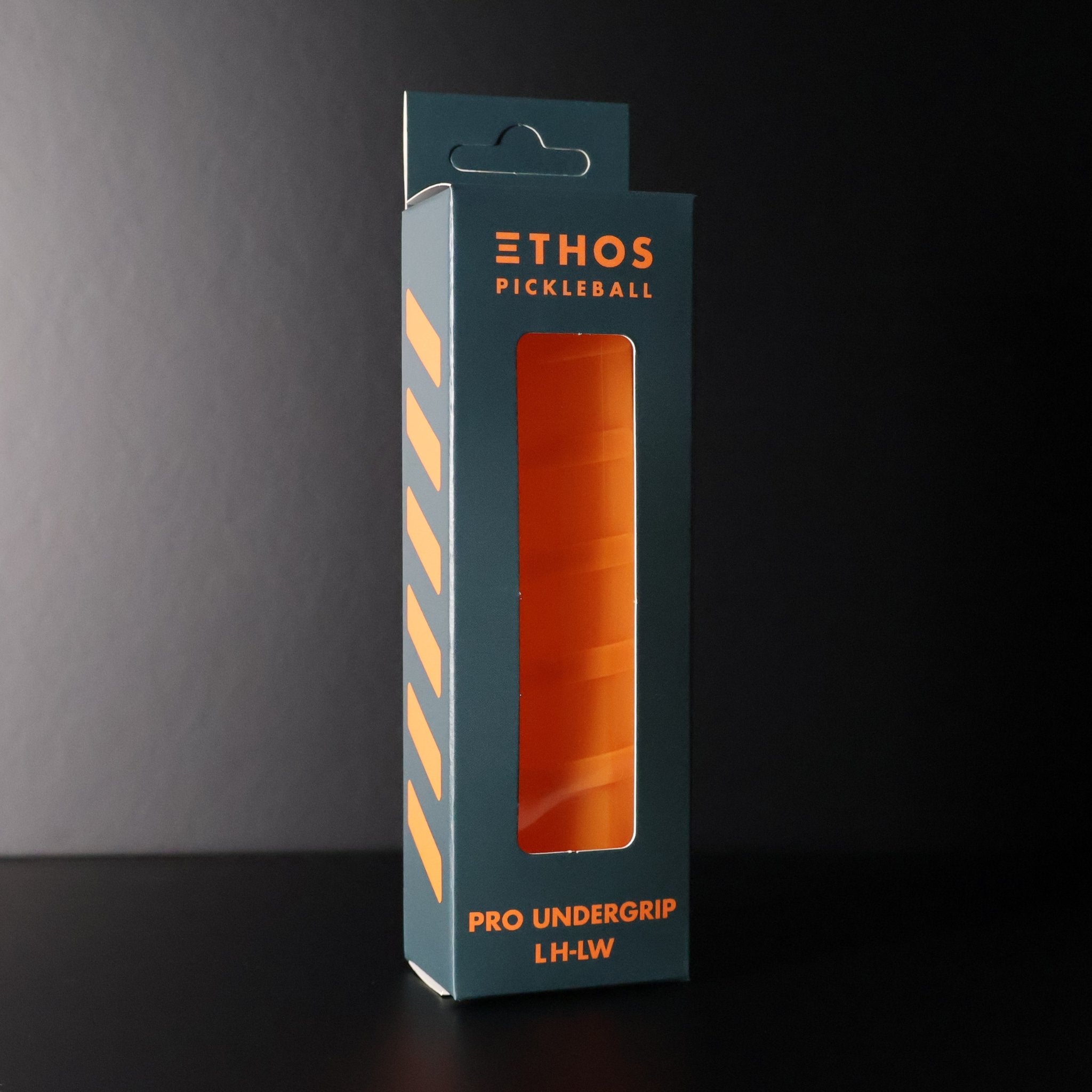 Orange Pro Undergrip by Ethos Pickleball in a dark teal package with orange diagonal stripes and clear display window.