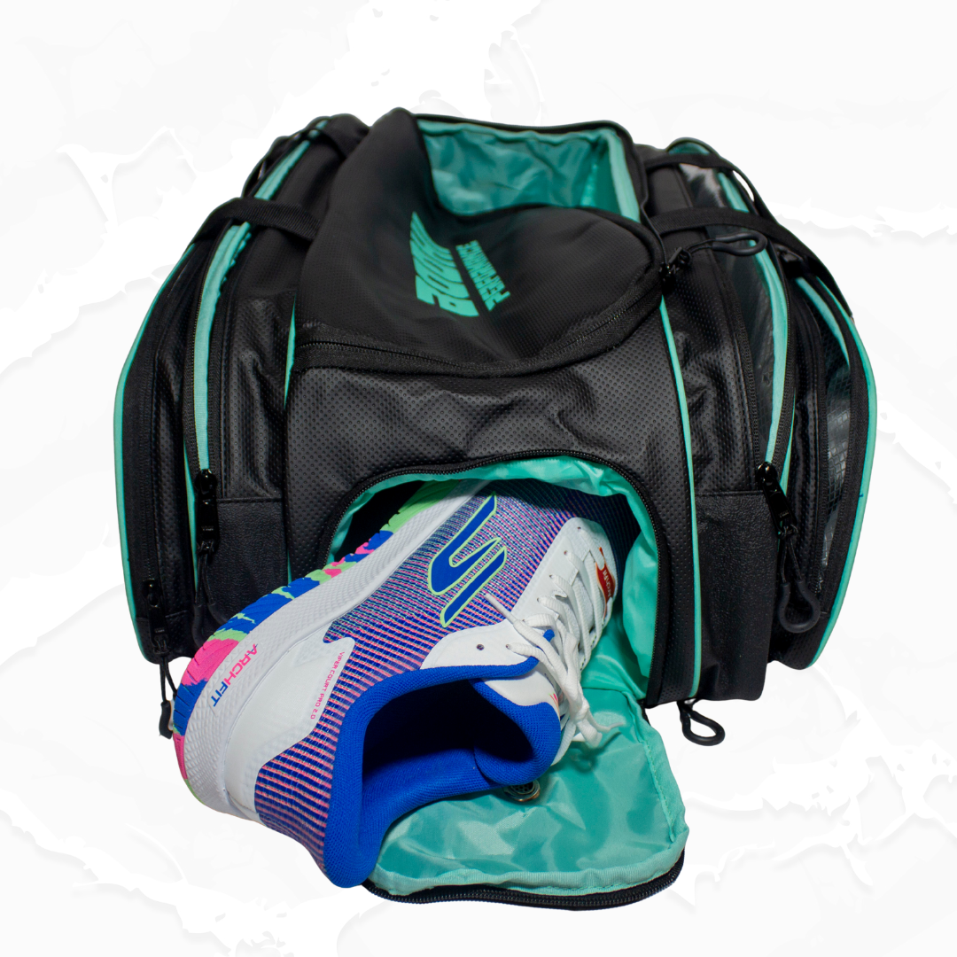 Black and teal duffle bag by Bodhi Pickleball, featuring a teal 'BODHI PERFORMANCE' logo, with an athletic shoe emerging from an open side pocket.