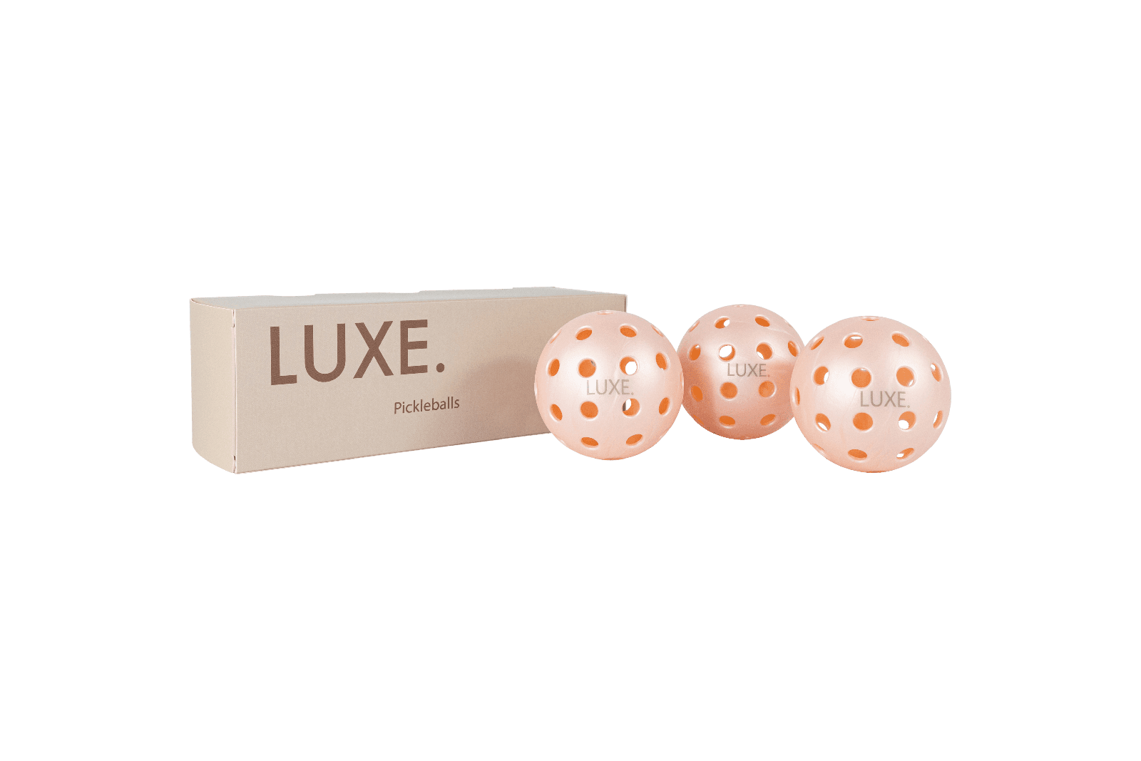 A box of Luxe pickleballs with three Luxe pickleballs next to it.