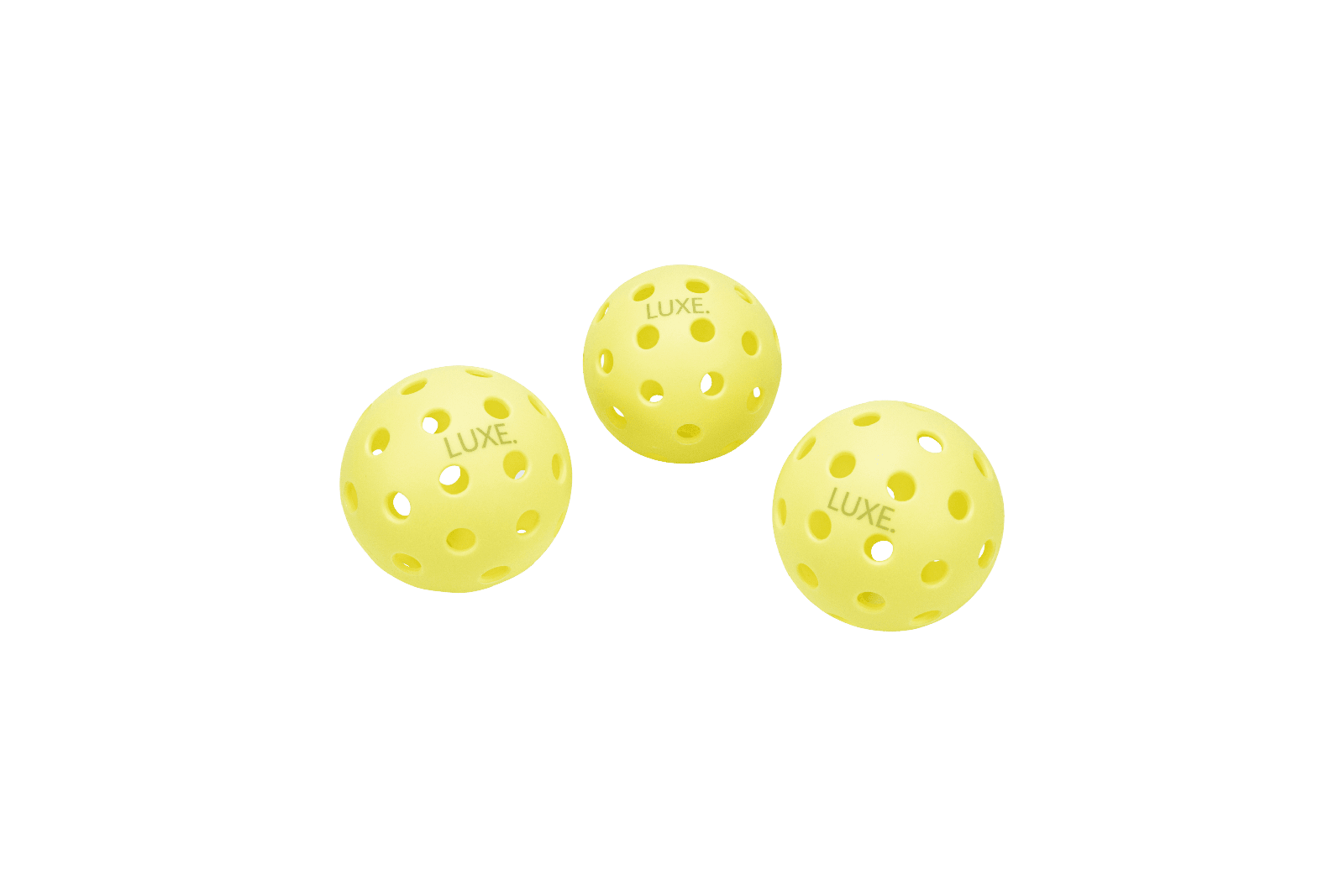Three yellow pickleballs with "LUXE" written on them against a green background.