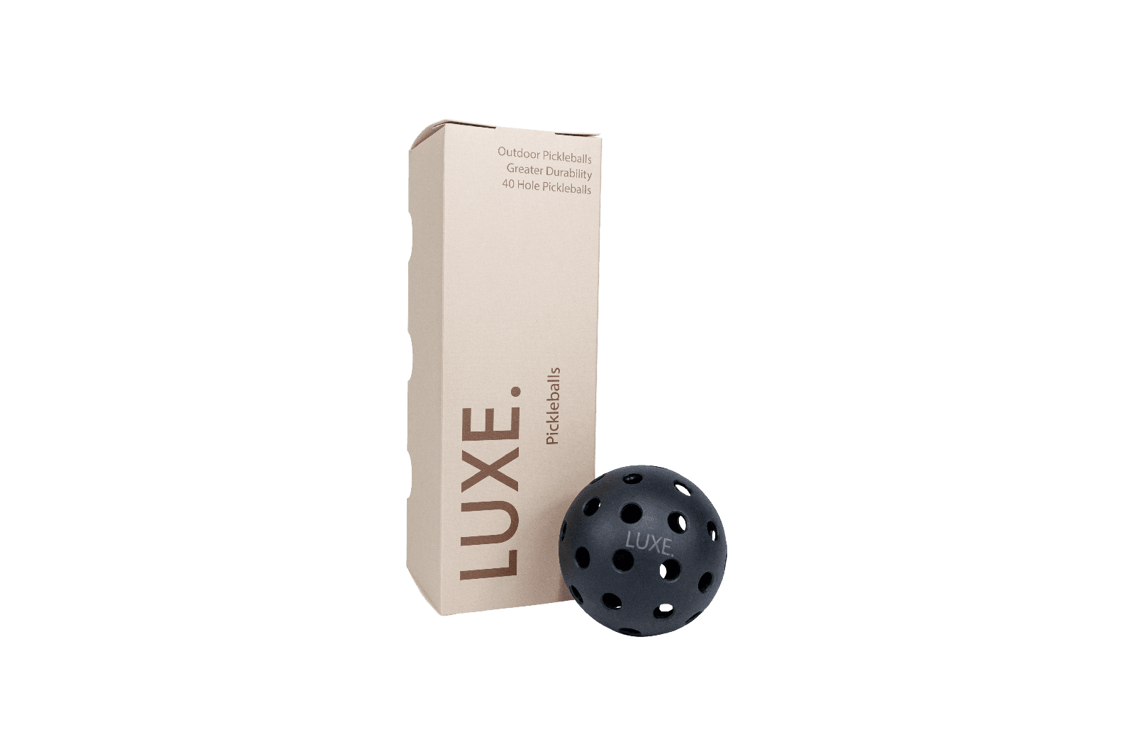 A pickleball box with the words "LUXE" on the front, and a black pickleball with the word "LUXE" on it.