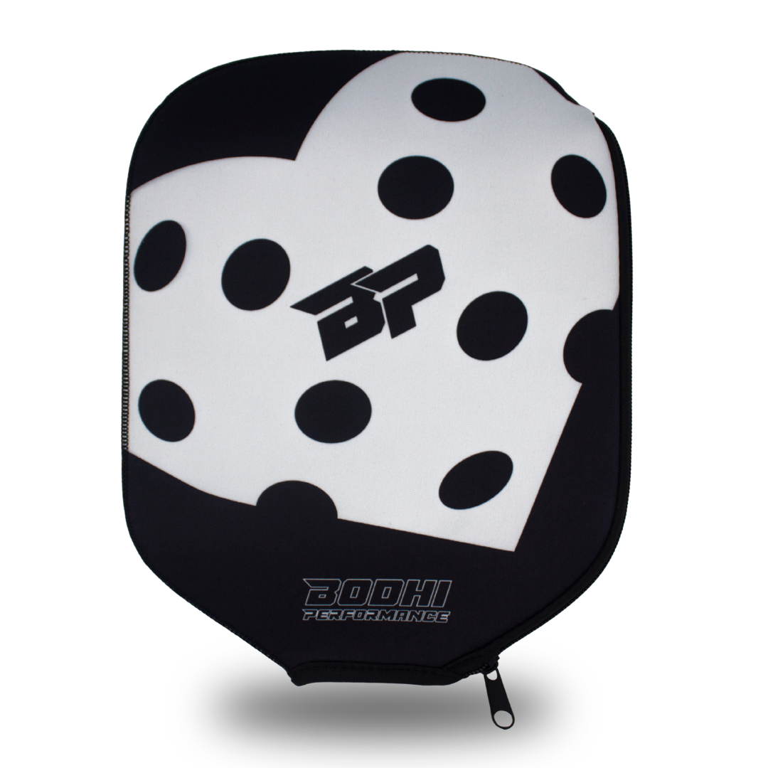 Black and white polka dot paddle cover by Bodhi Performance with a heart design, "BP" logo, and visible zipper.
