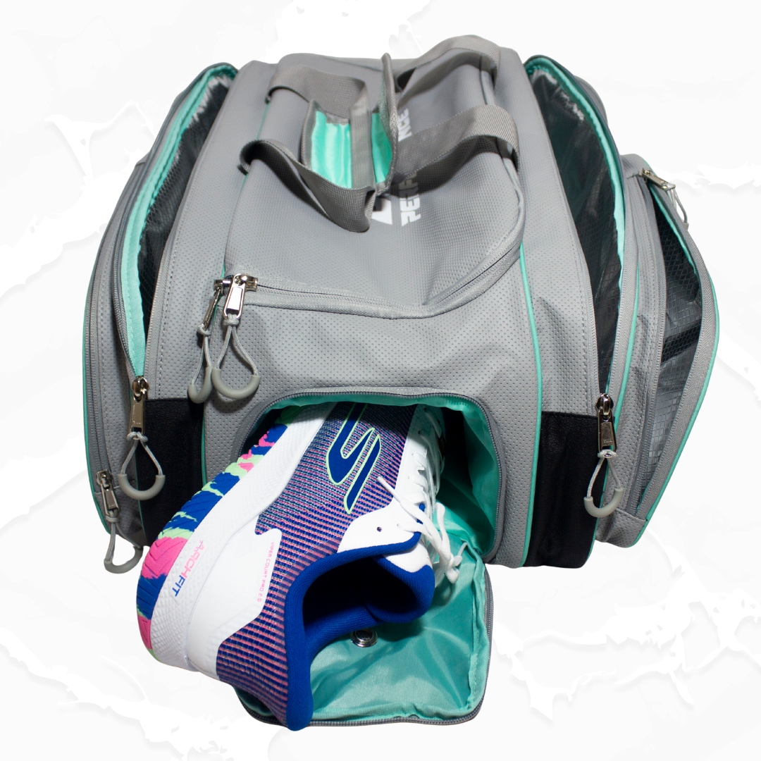 Grey and teal duffle bag by Bodhi Pickleball, with a colorful athletic shoe emerging from an open compartment.