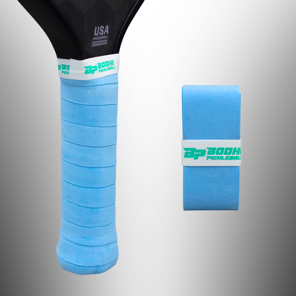 Light blue textured overgrip by DRYtack with white band and green logo, shown wrapped on paddle handle and rolled separately.