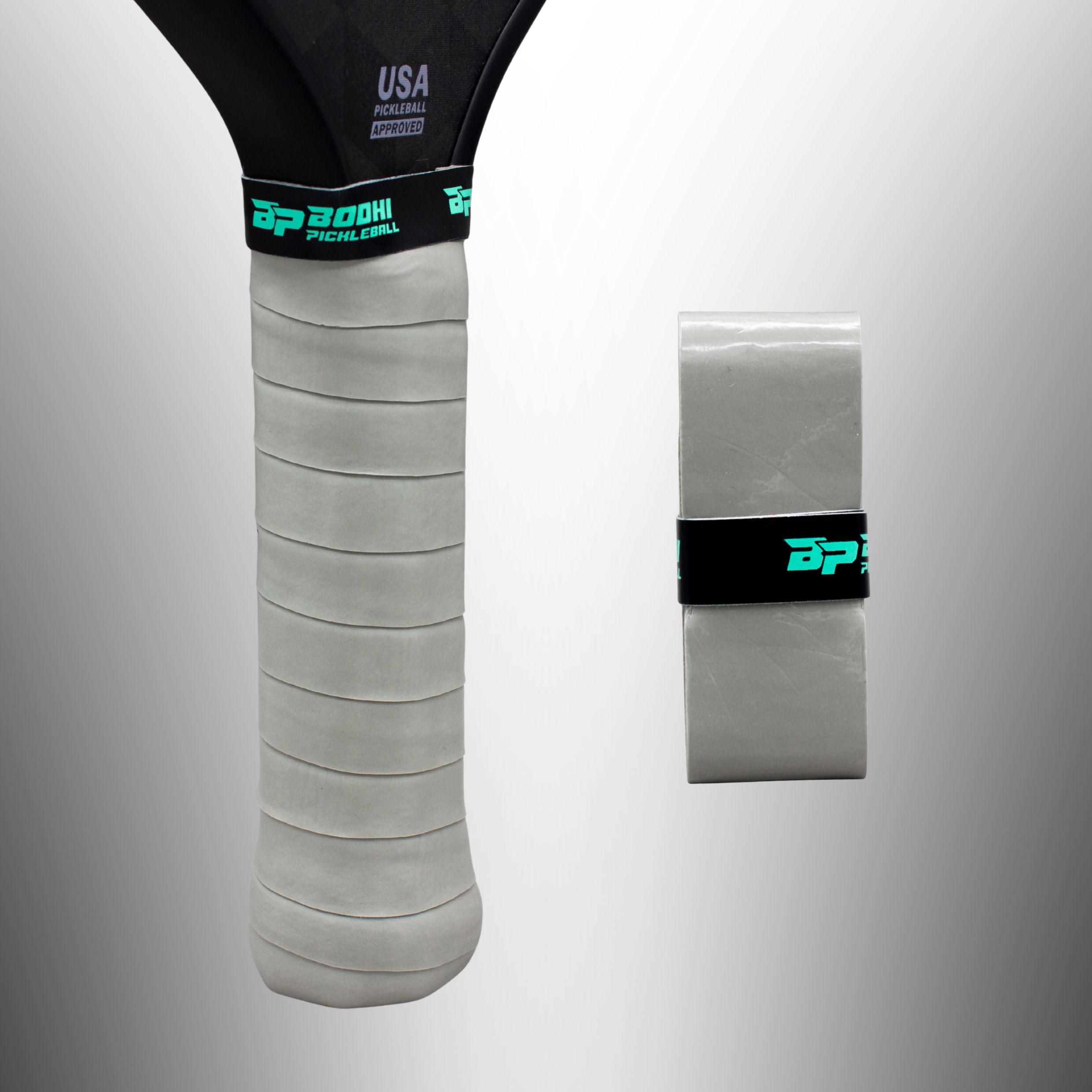 Light gray textured pickleball paddle overgrip by Bodhi Pickleball, with branded bands, shown on a paddle handle and rolled.