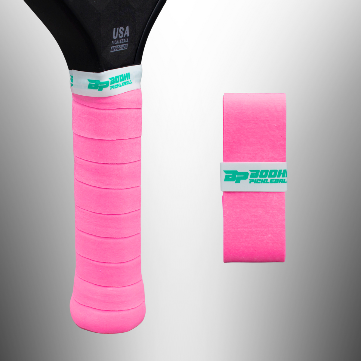 Bright pink DRYtack overgrip by Bodhi Pickleball, wrapped on racket handle with textured surface and white band featuring teal logo, shown alongside rolled grip.