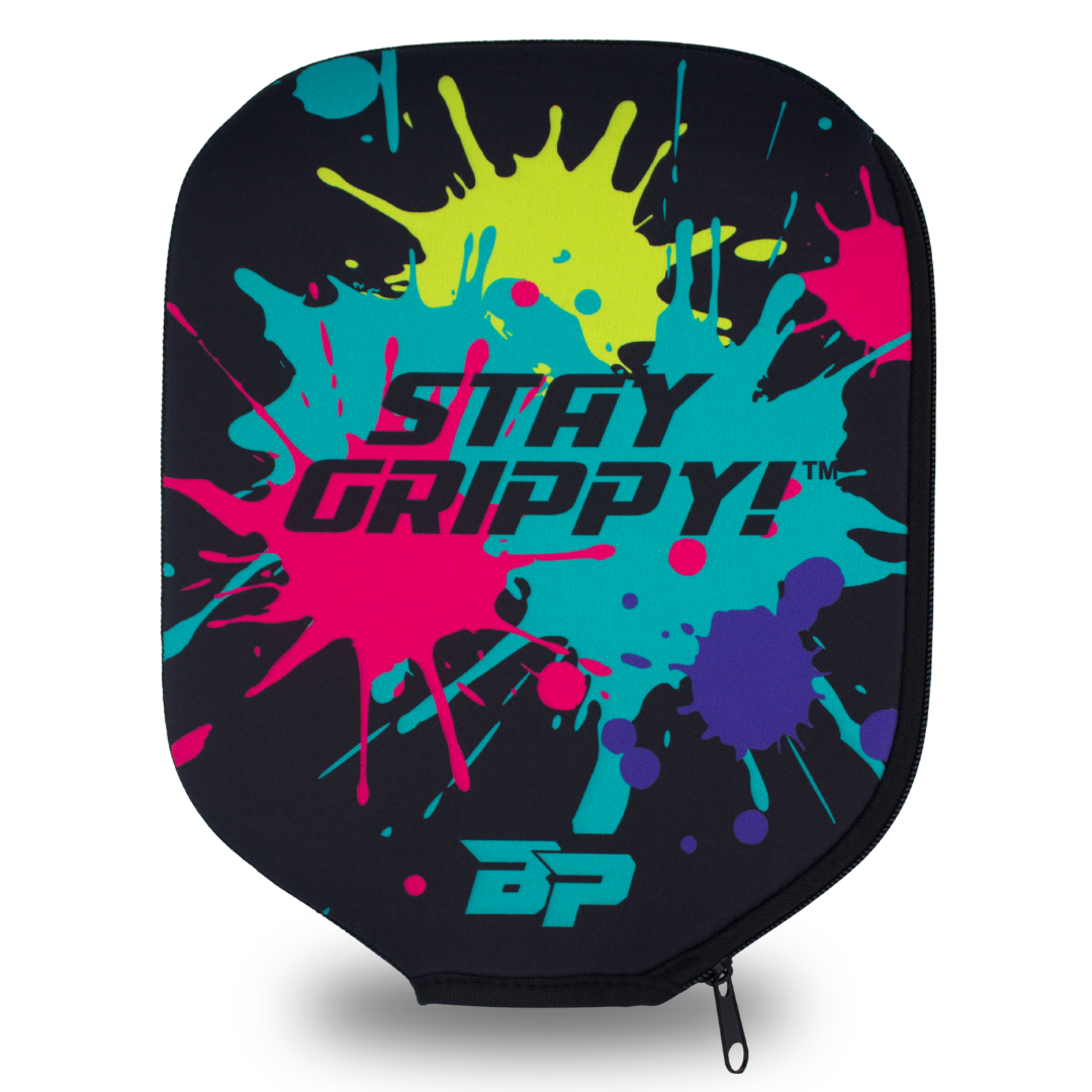 Black neoprene paddle cover by Bodhi Performance featuring "STAY GRIPPY!" text, colorful paint splatters, and a side zipper.