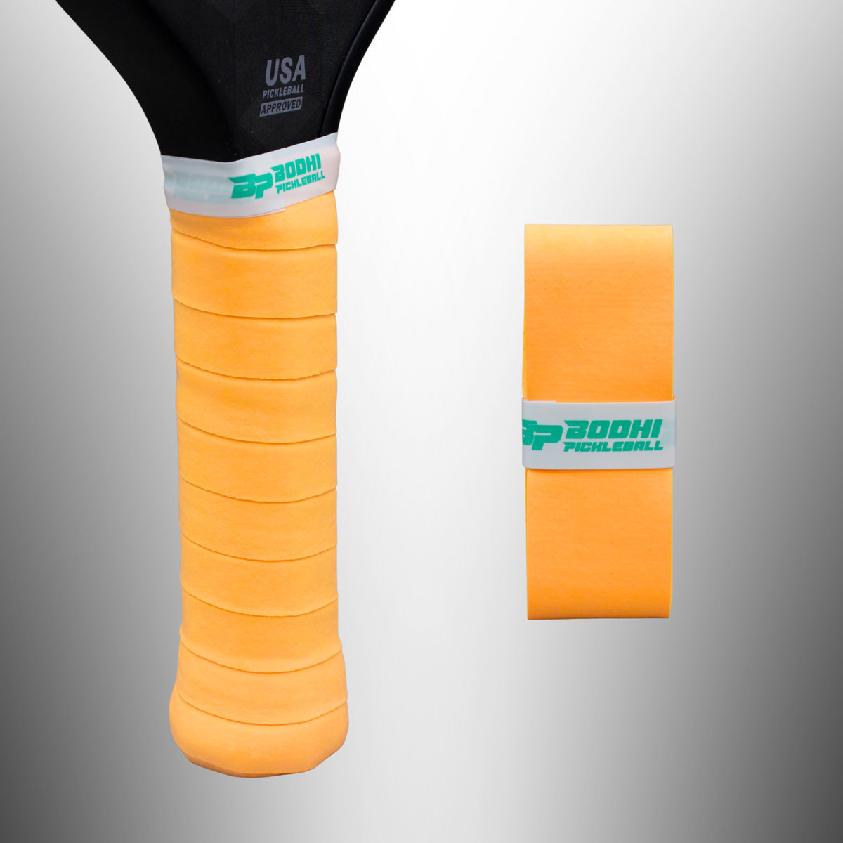 Orange textured overgrip by DRYtack with white band and green logo, shown on pickleball paddle handle and rolled view