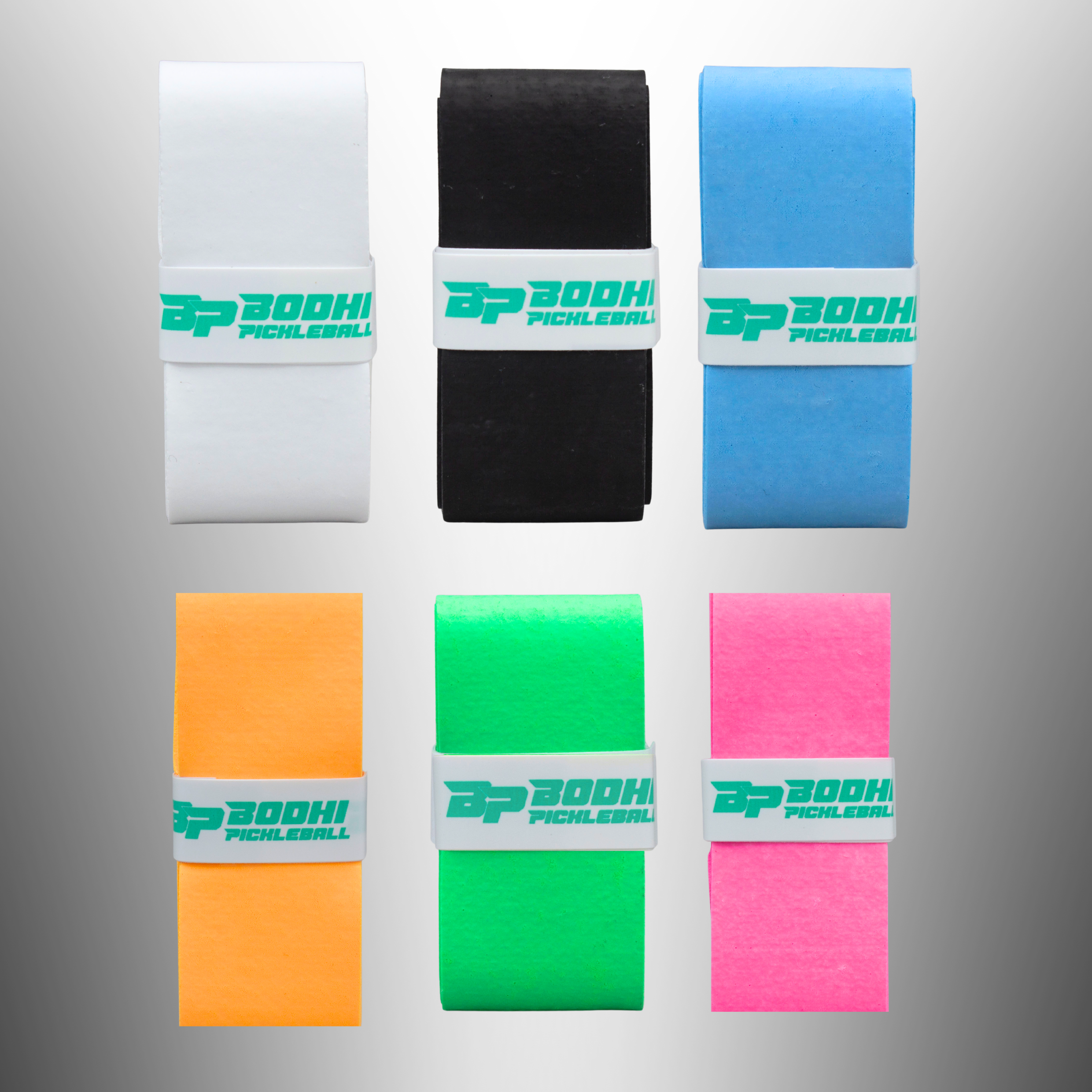 Six DRYtack overgrips in white, black, blue, orange, green, and pink by Bodhi Pickleball, each secured with a logo band.