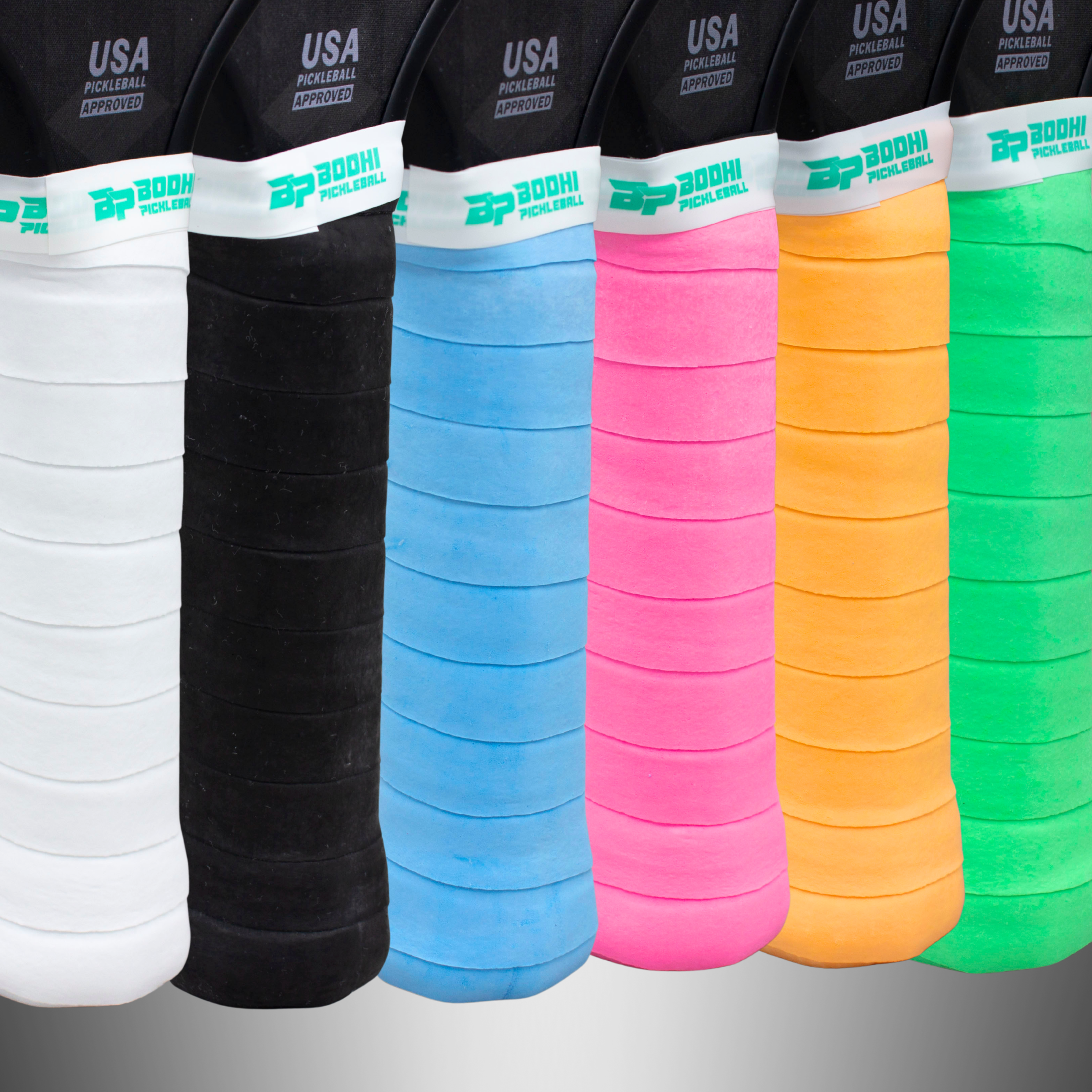 Six DRYtack Overgrips by Bodhi Pickleball in white, black, blue, pink, orange, and green, featuring ribbed texture, BP logo, and USA Pickleball Approved text.