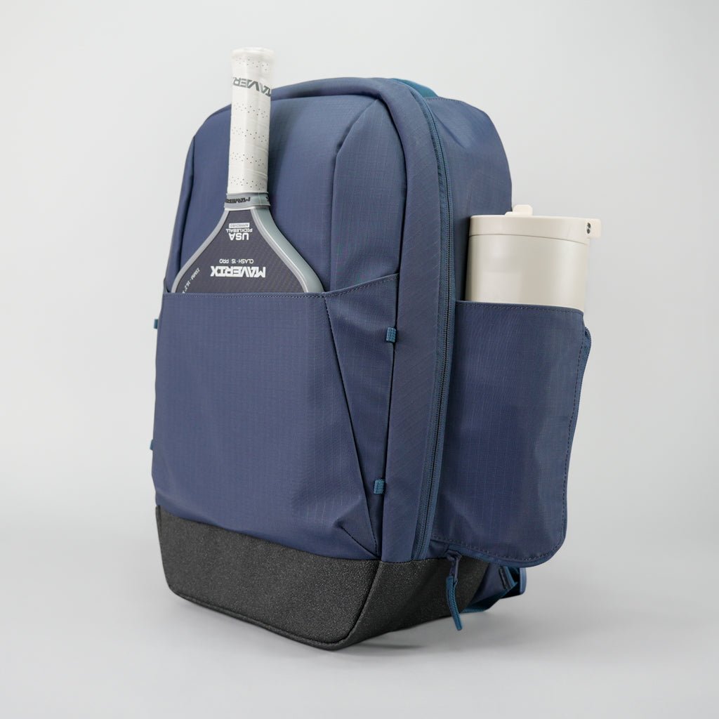 A blue backpack with a tennis racket and water bottle.