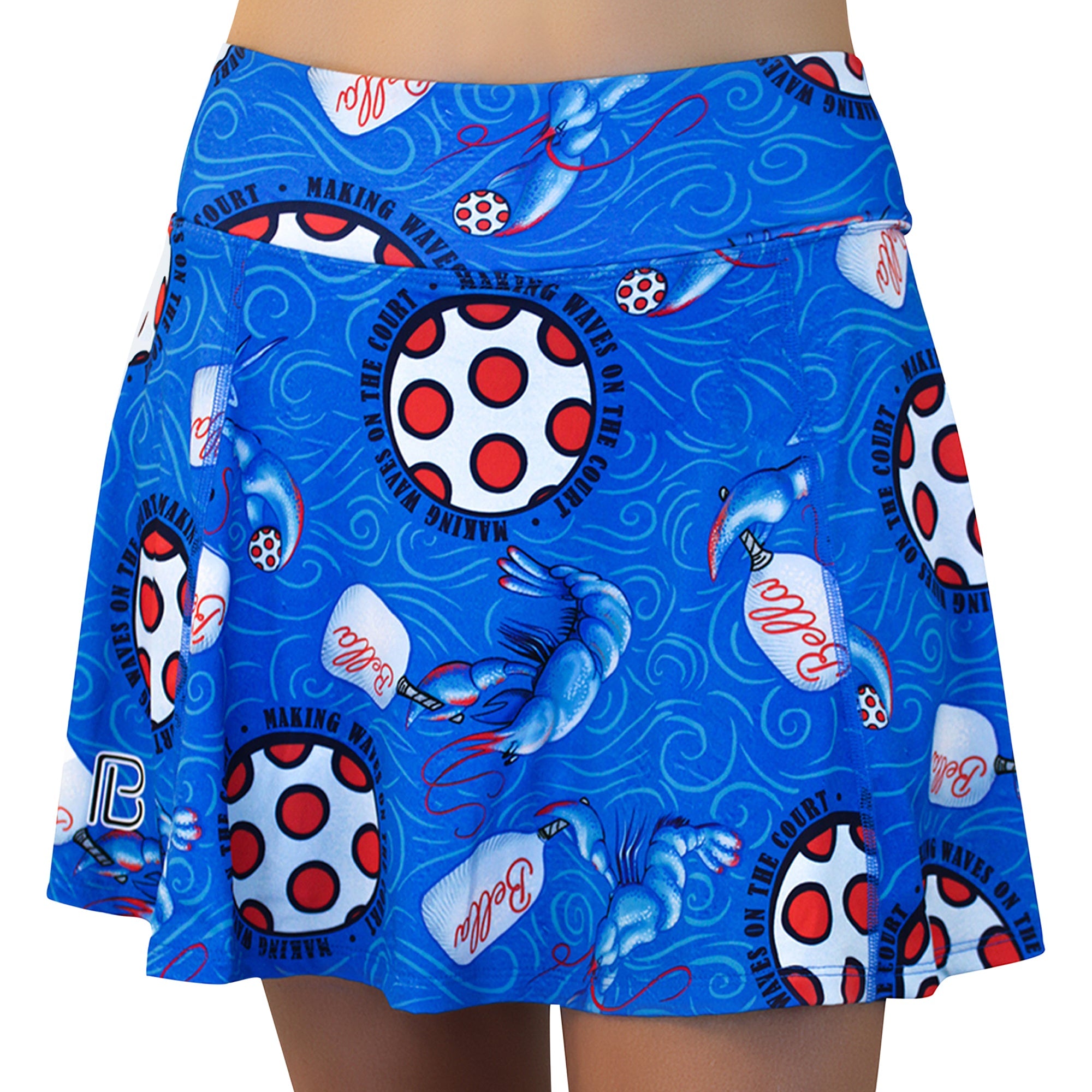 Blue A-line skort by Pickleball Bella featuring a lobster, pickleball, and paddle print on a swirling blue background, front view.