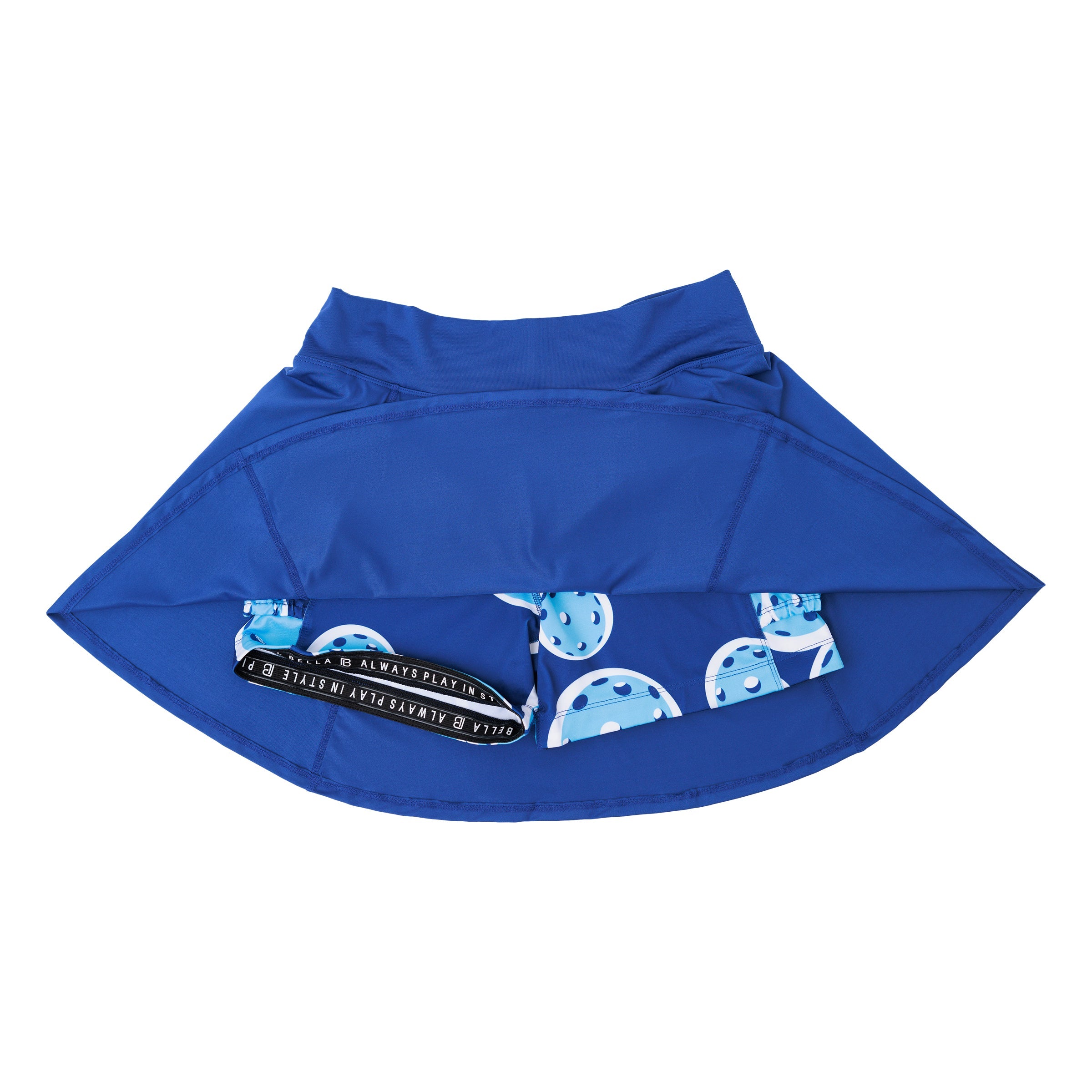 Navy A-line skort by Pickleball Bella, viewed from beneath, revealing built-in shorts with a pickleball pattern and a branded elastic waistband.