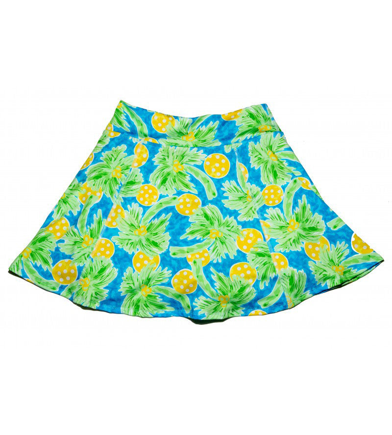 A-line skort in blue, green, and yellow by Pickleball Bella, featuring a tropical palm tree and polka-dotted ball pattern.