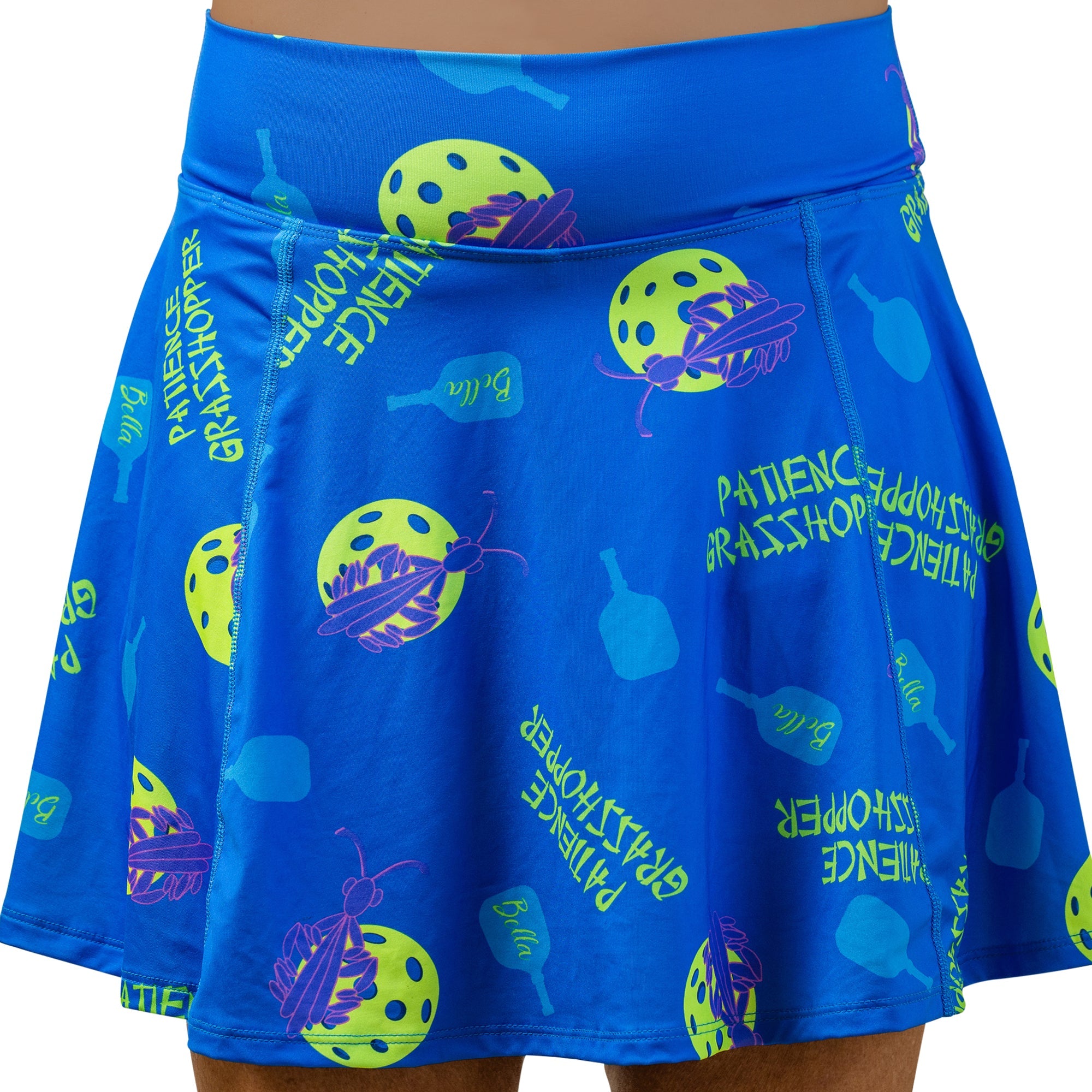 Blue A-line skort by Pickleball Bella with pickleball and grasshopper pattern, and "Patience Grasshopper" text.