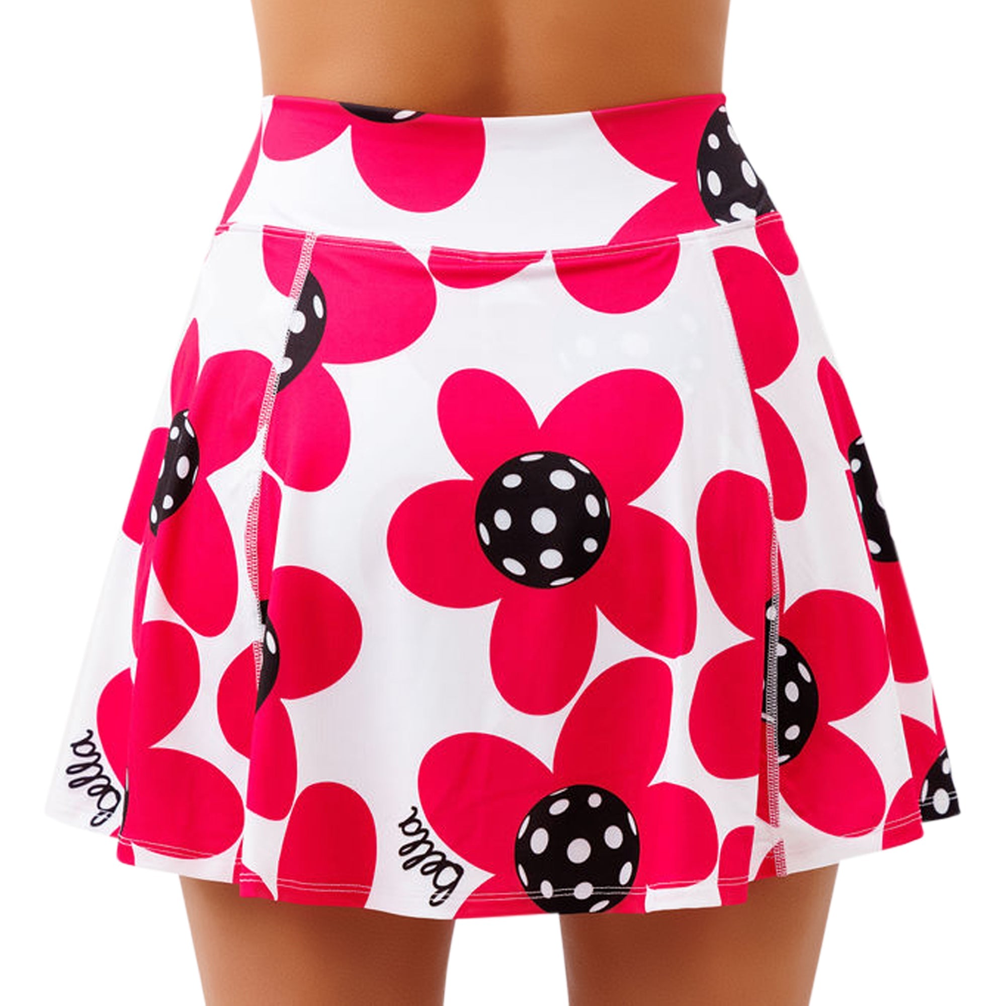 A white A-line skort by Pickleball Bella with fuchsia flowers, black polka dot centers, and a script 'bella' logo.