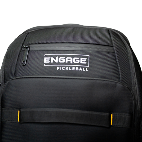 Black textured backpack by EngagePickleball featuring the white 'ENGAGE PICKLEBALL' logo, a zippered top pocket, and a lower strap with yellow accents.