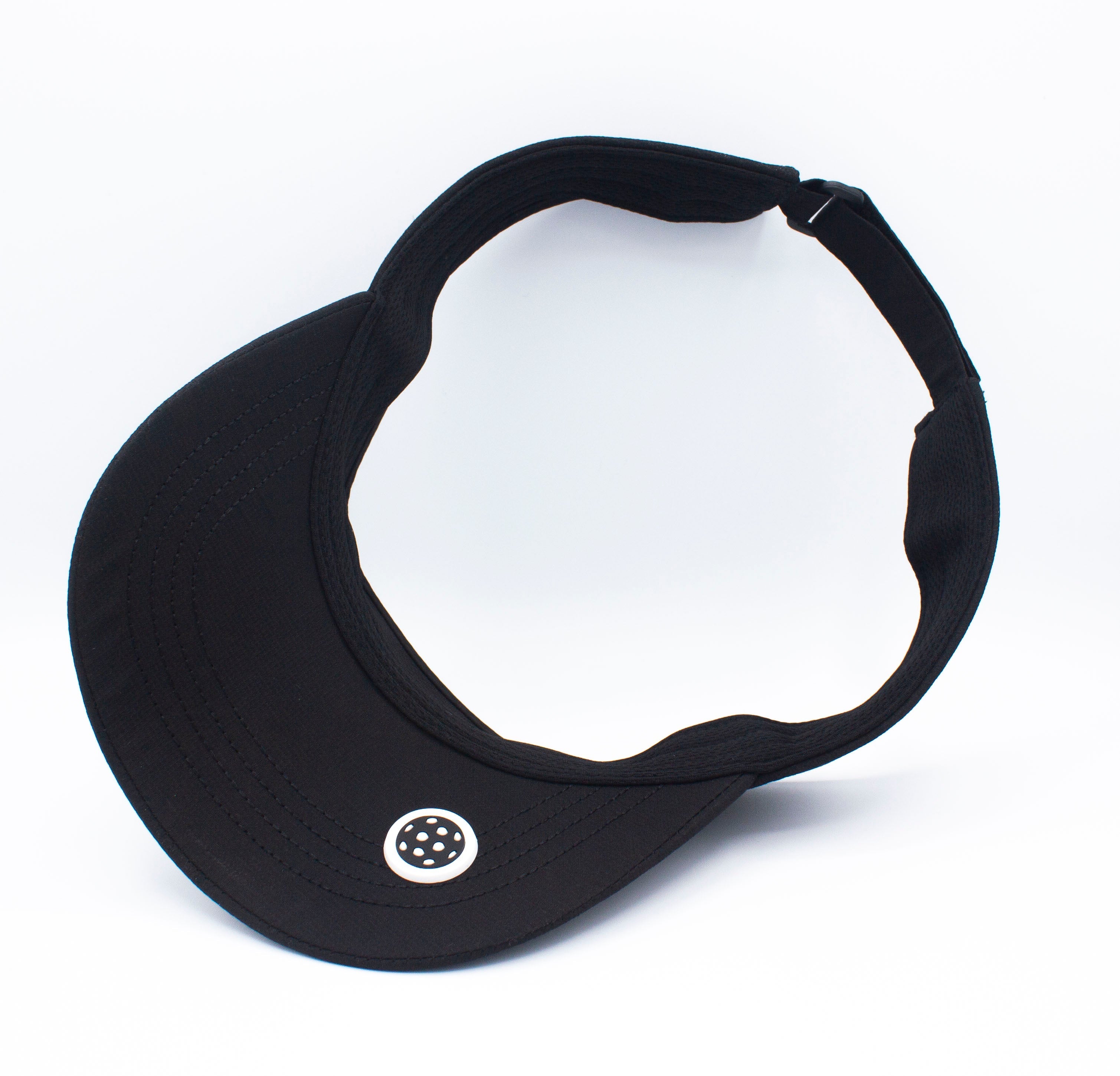 Black visor with a patterned white button, isolated on a white background.