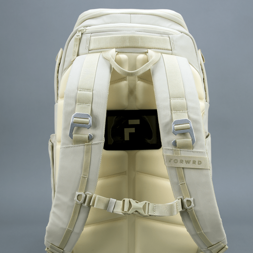 Light beige Pickleball Backpack by FORWRD, back view, with padded straps, metal hooks, and a visible 'F' logo.