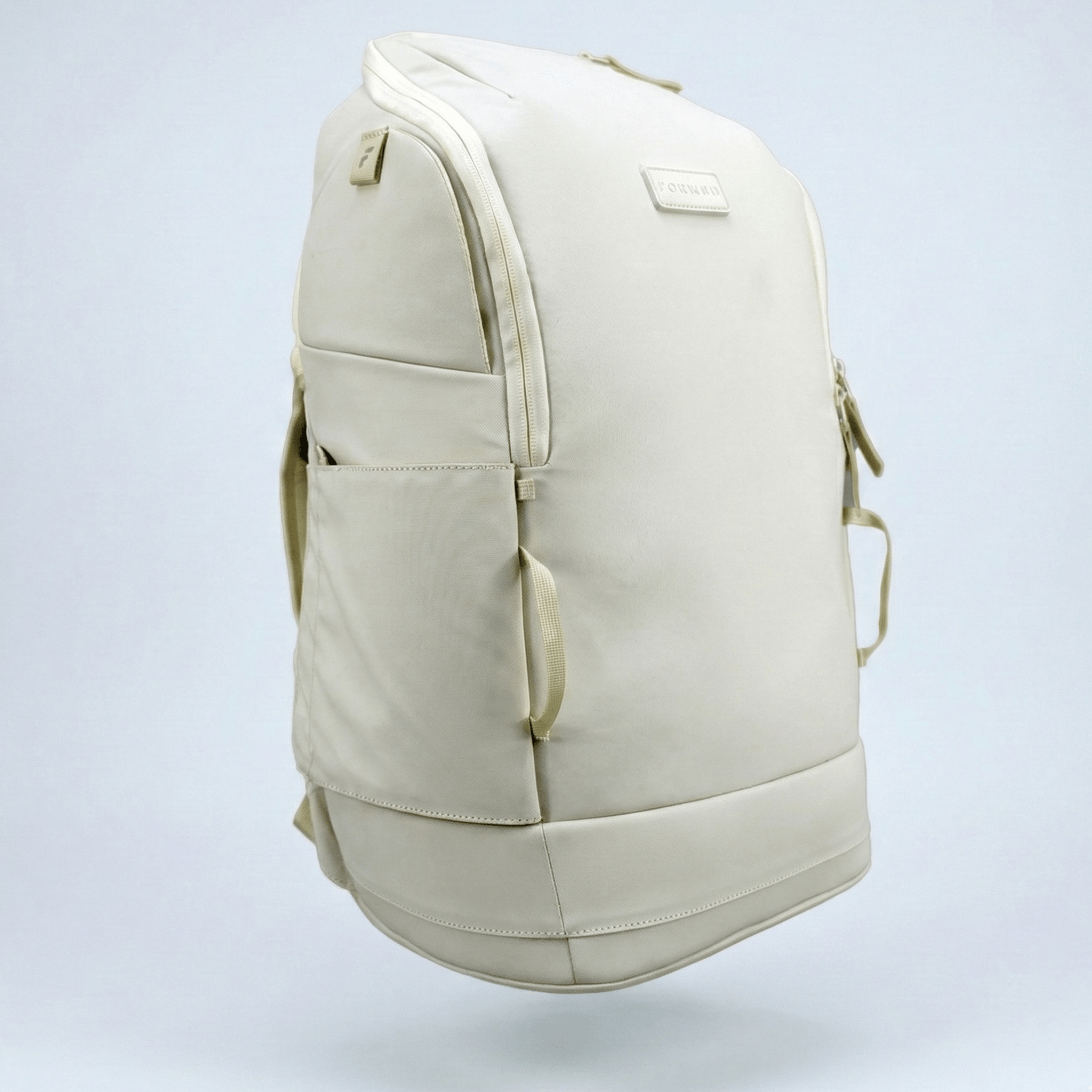 Light beige pickleball backpack by FORWRD with an embossed logo, front pocket, and side view.