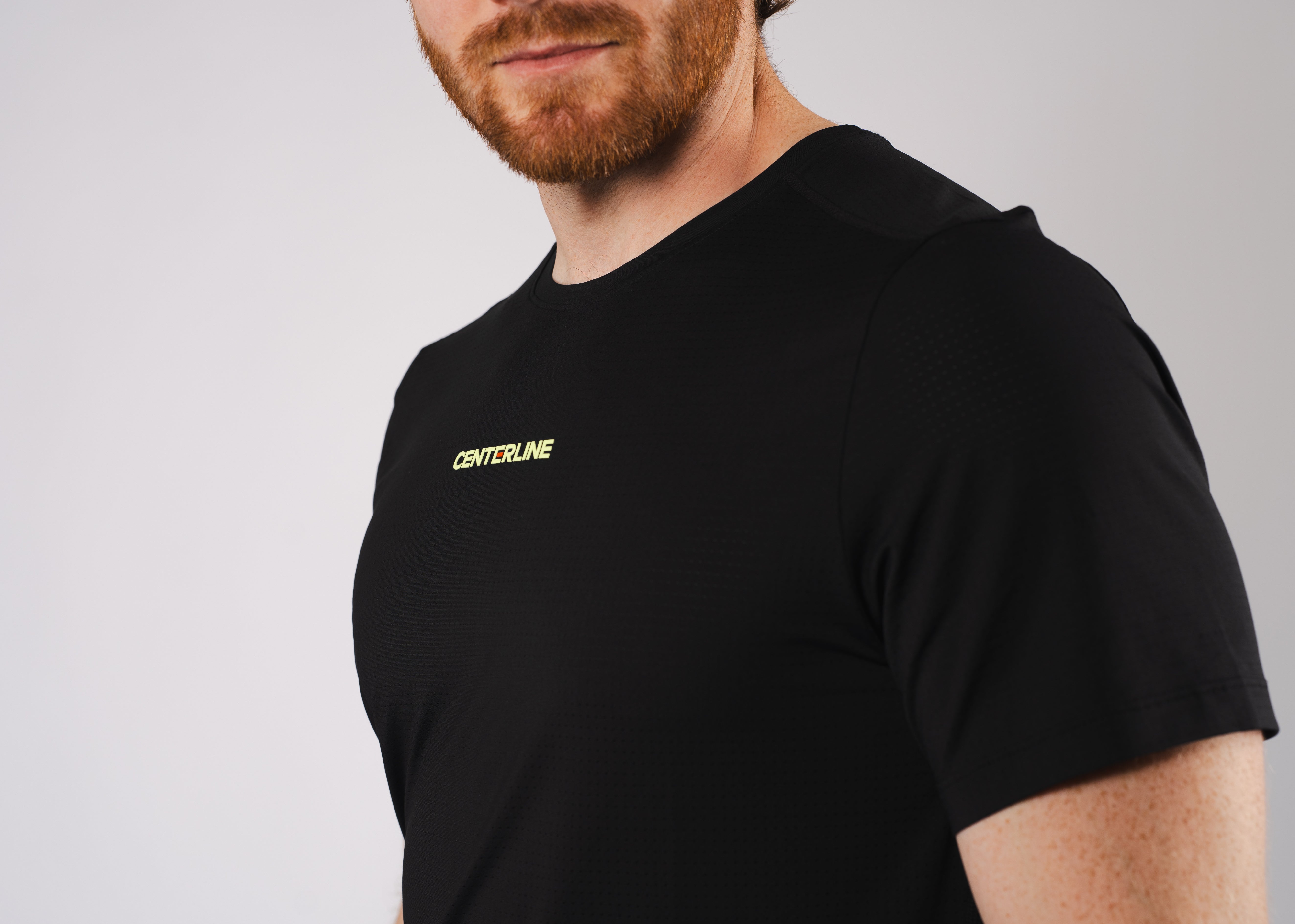 Man in black athletic T-shirt with red beard.