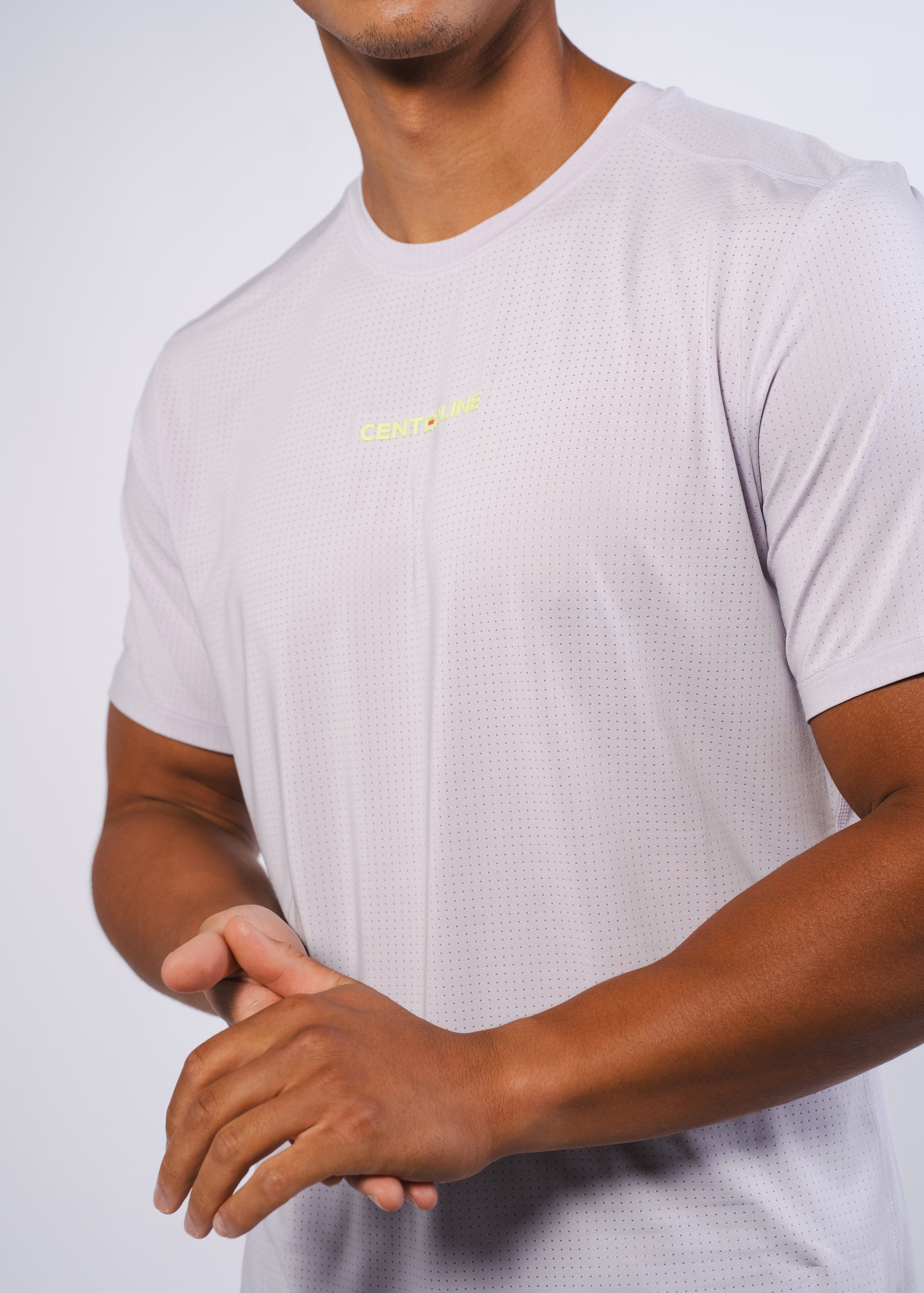 Man in heather-gray t-shirt with a micro-dot pattern.