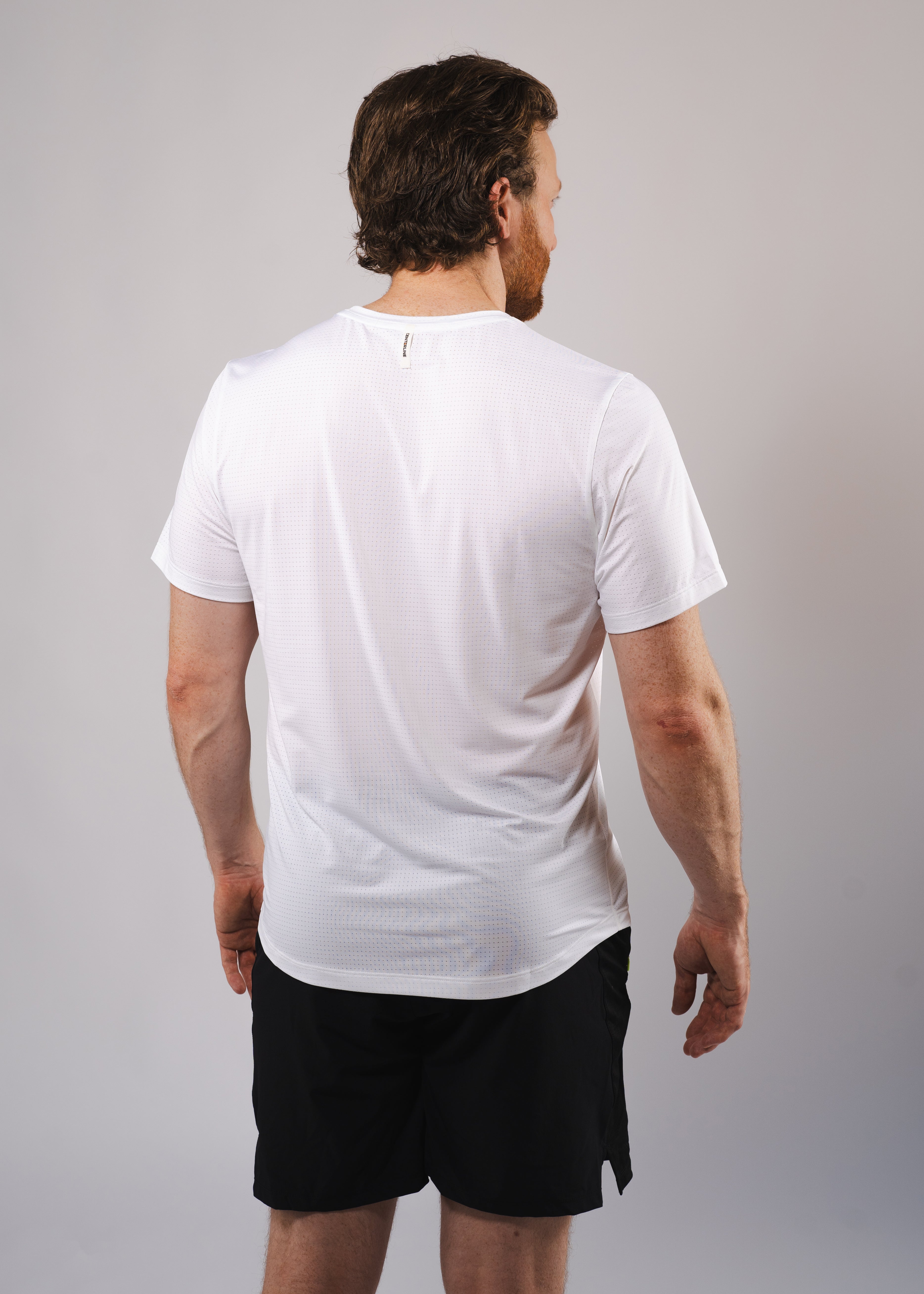 Man in white athletic t-shirt and black shorts, back view.