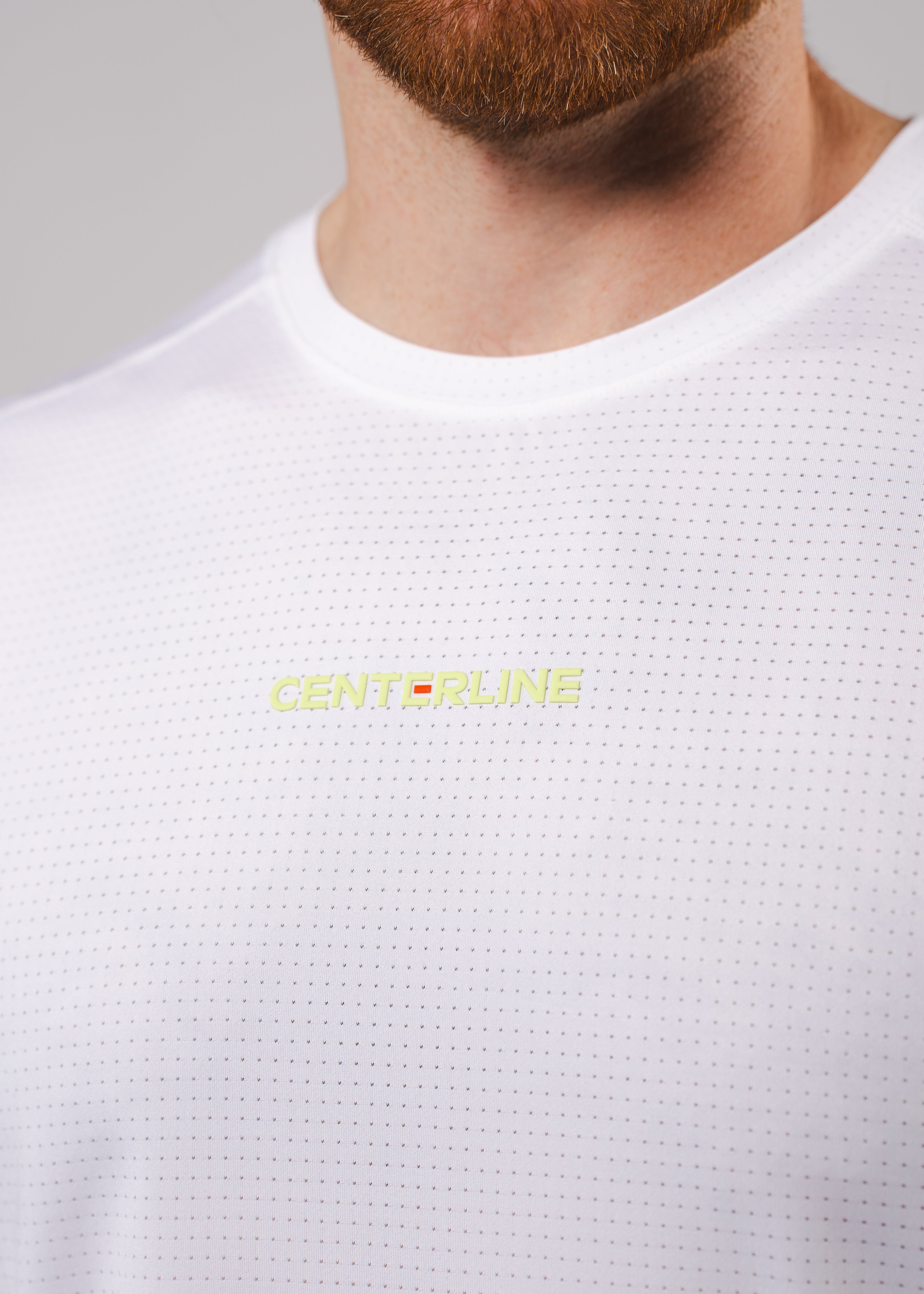 White mesh t-shirt with yellow logo.
