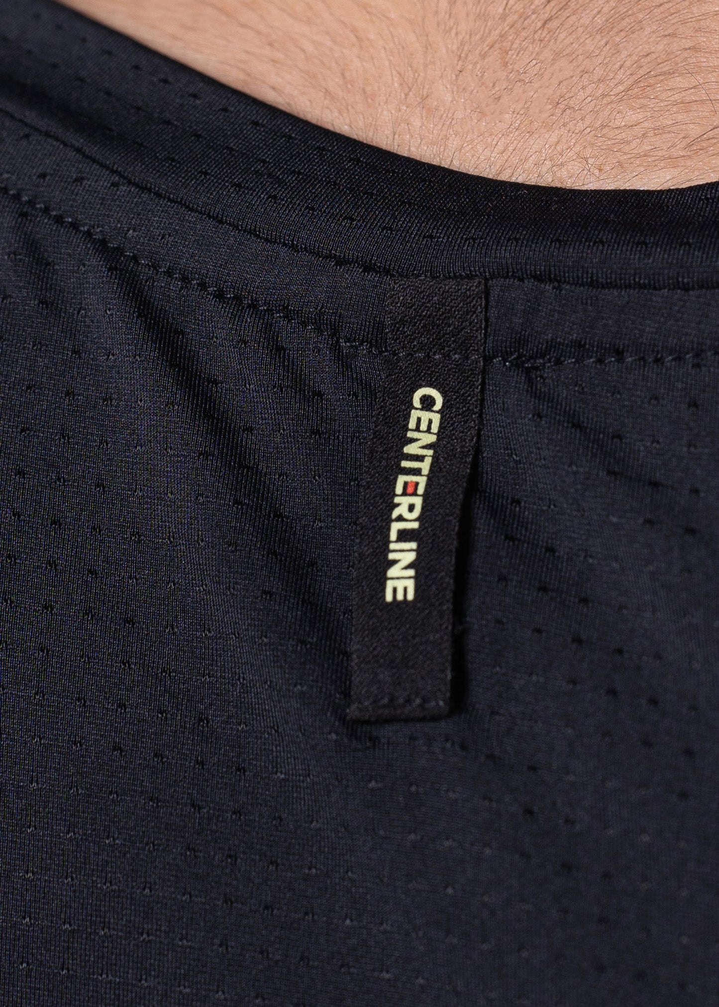 Close-up of a black mesh shirt collar with the "CENTERLINE" logo tag.