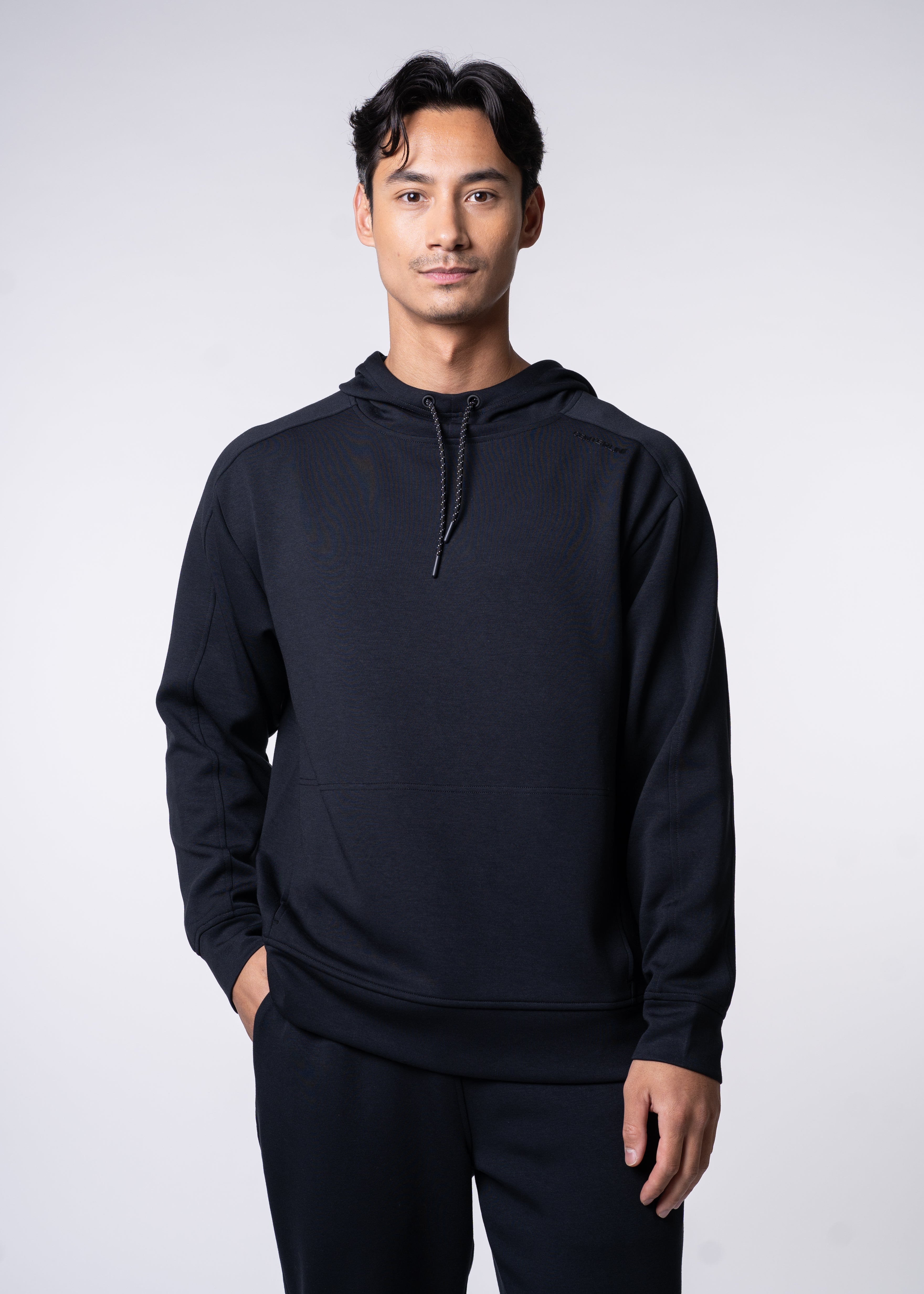 Man in a black hoodie and pants.