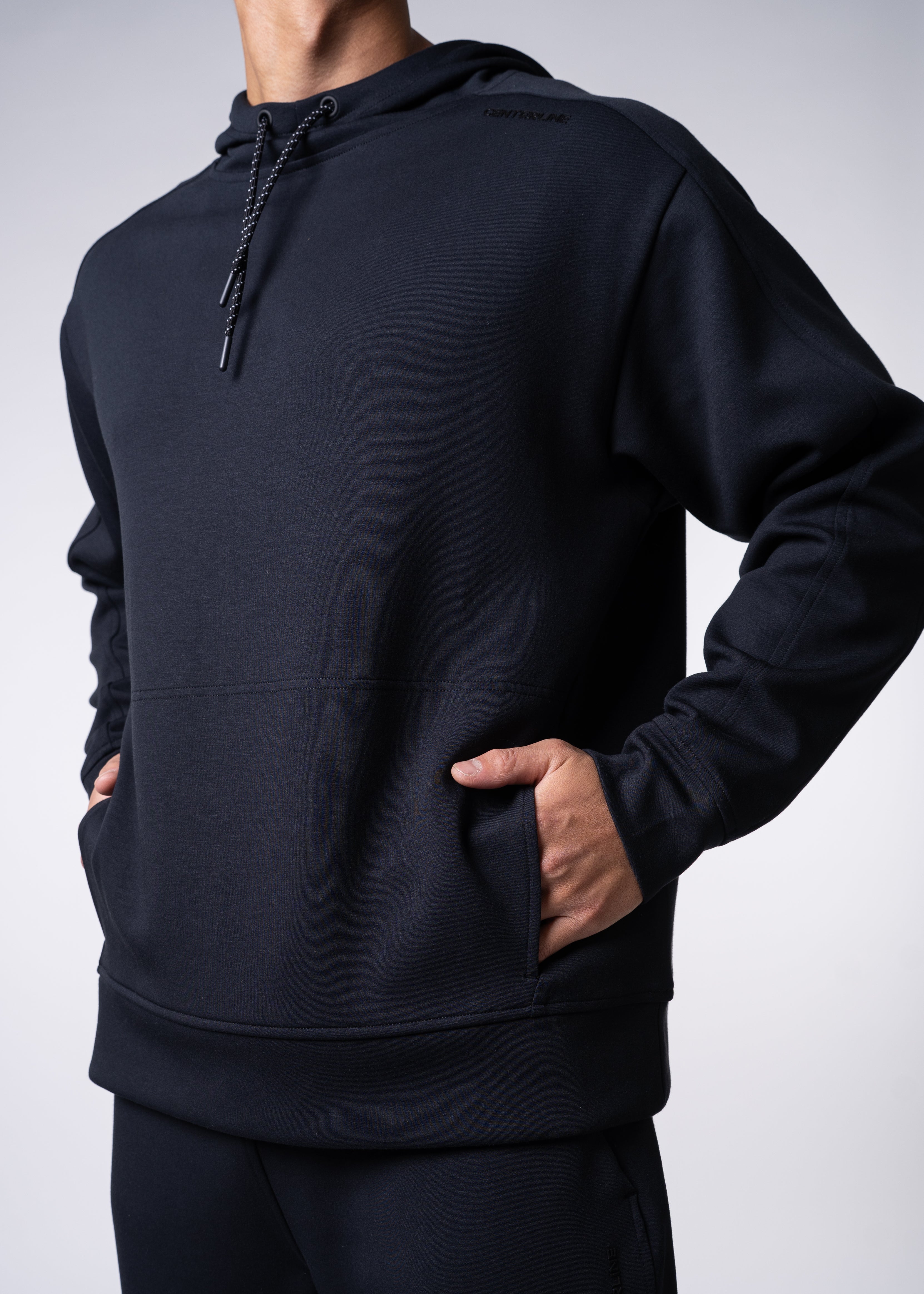Black hoodie with drawstring, front pocket, and matching pants.