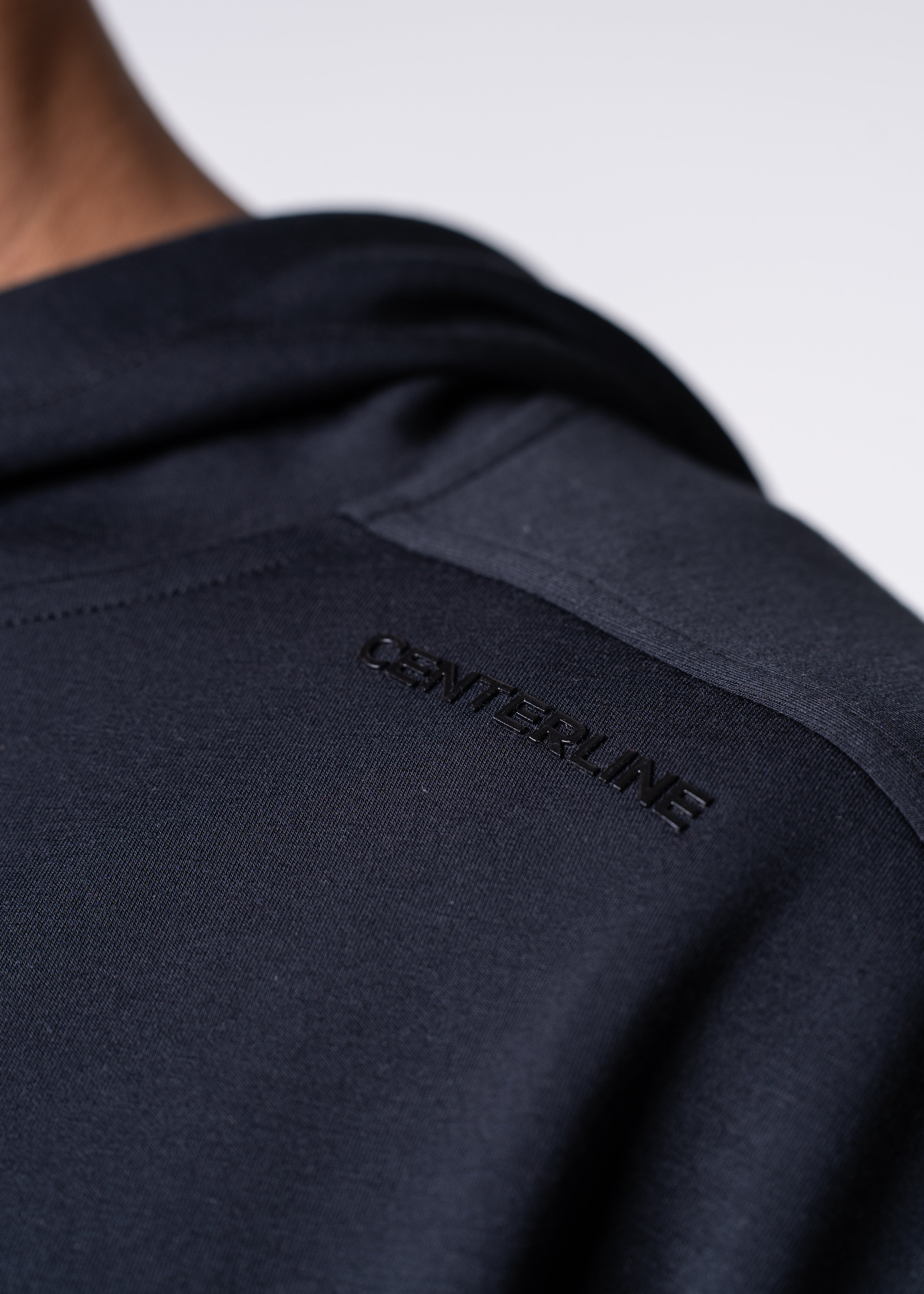 Close-up of dark blue garment with raised "CENTERLINE" text.