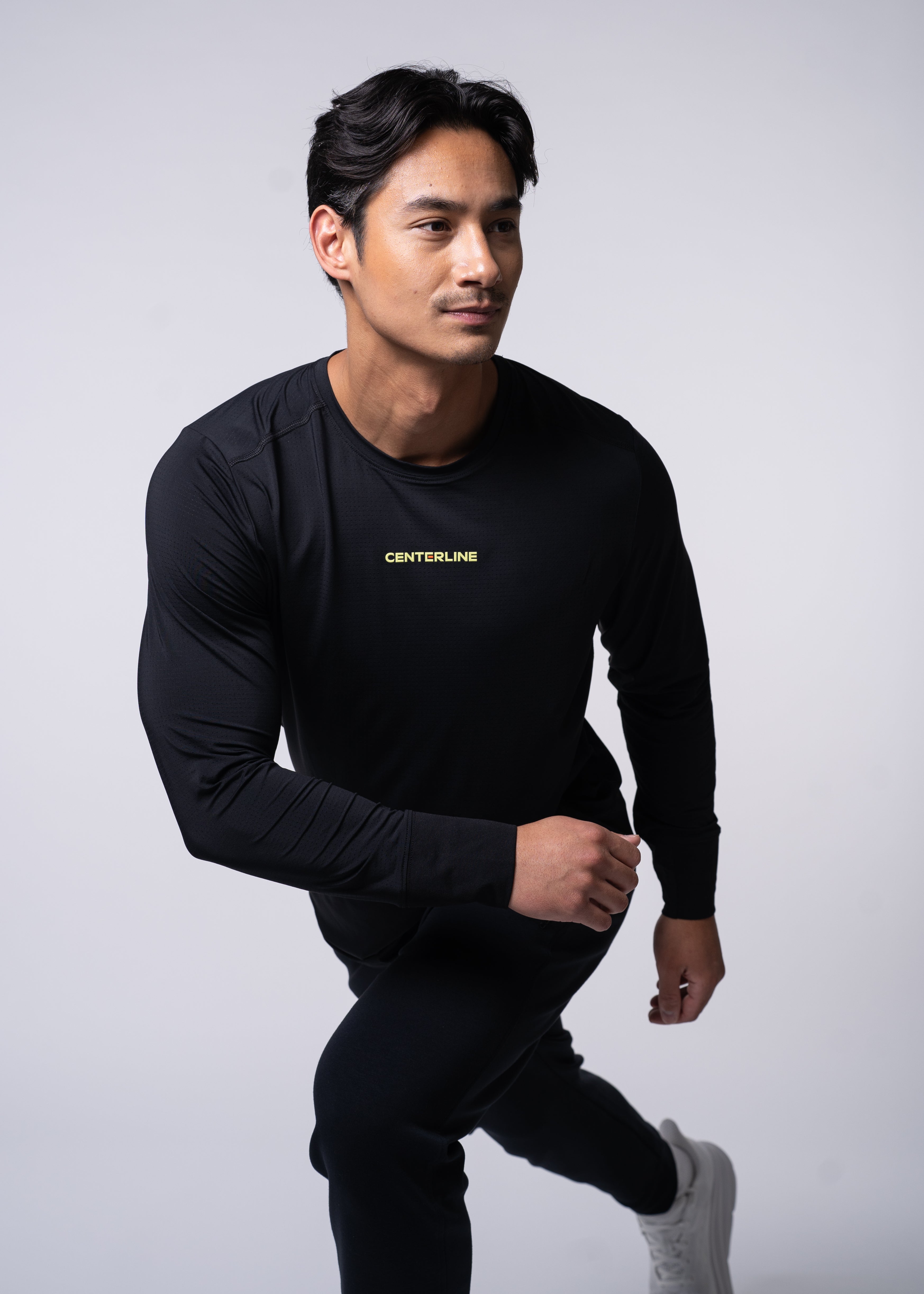 Man in black athletic wear in action pose.