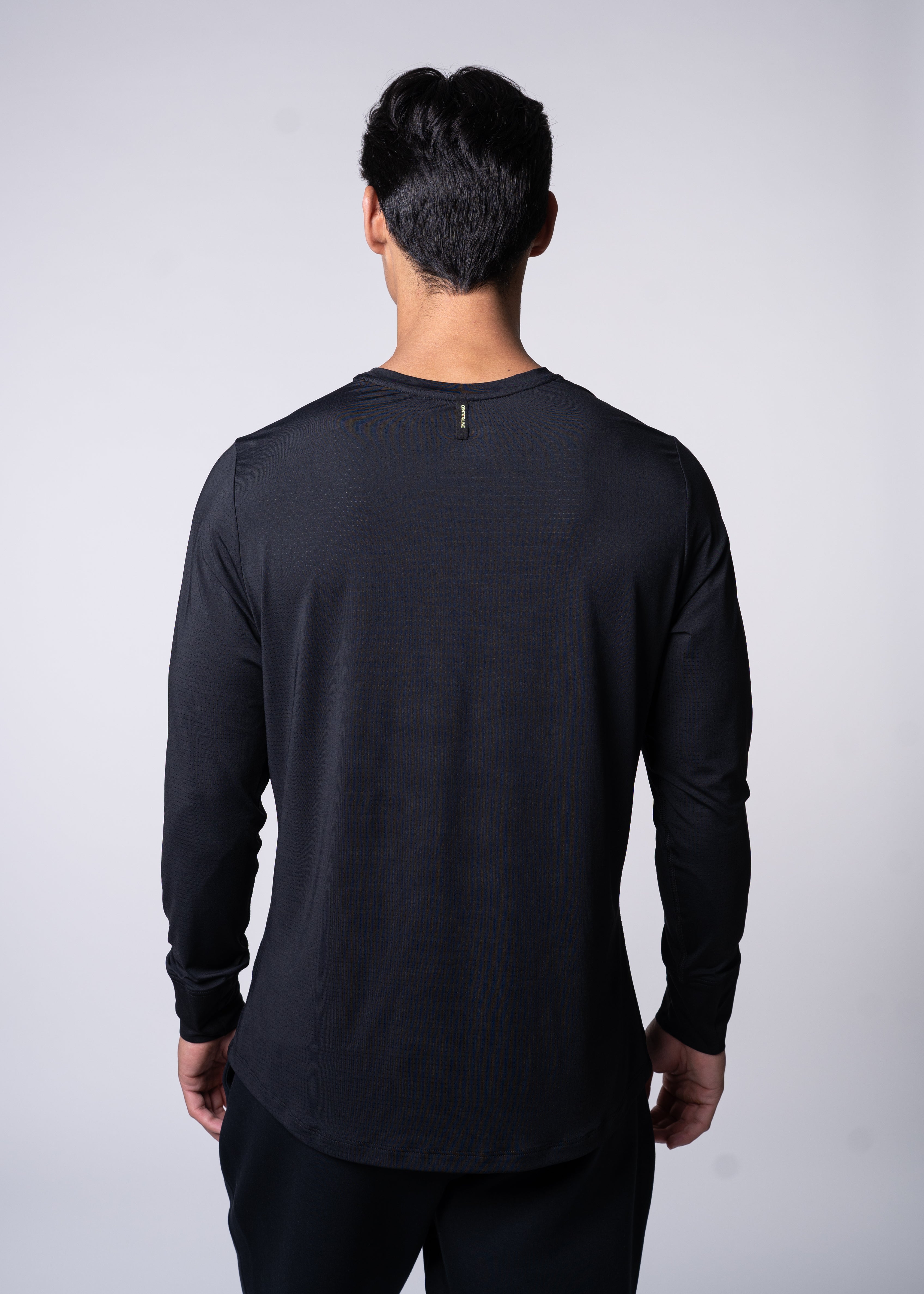 Back of person in long-sleeve black athletic shirt.