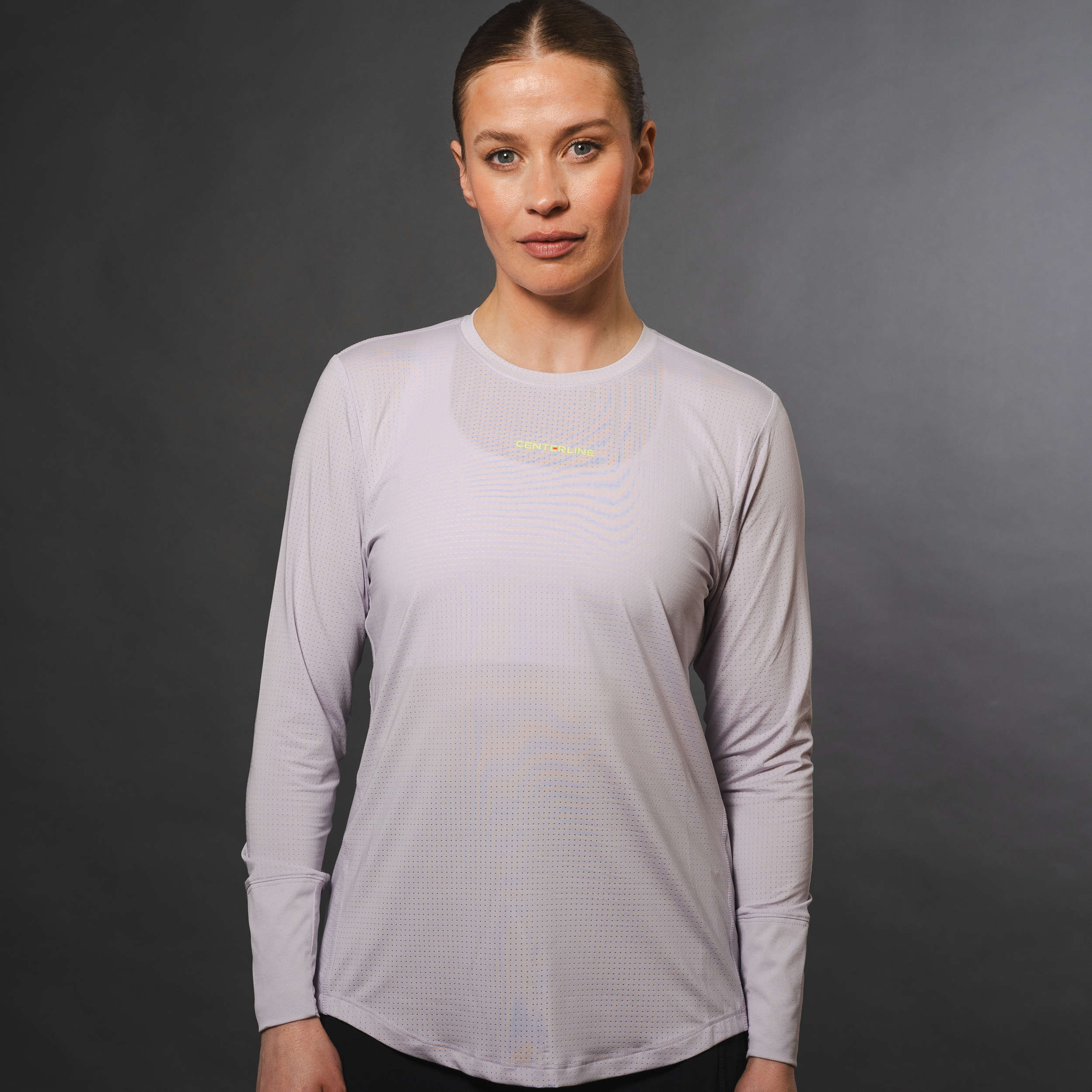 Woman wearing a lavender long-sleeved shirt with small perforations.