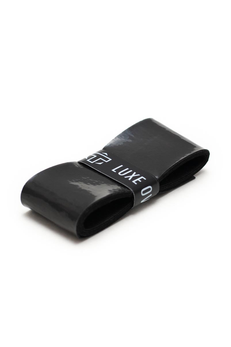 Glossy black overgrip by TMPR Sports, rolled with a white branded band featuring "TMPR LUXE O".