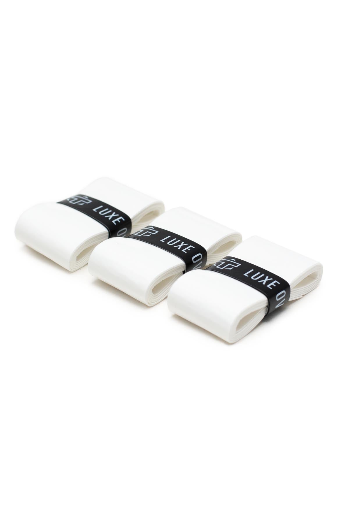 Three white overgrips by TMPR Sports, each secured with a black band featuring "LUXE" text, displayed diagonally.