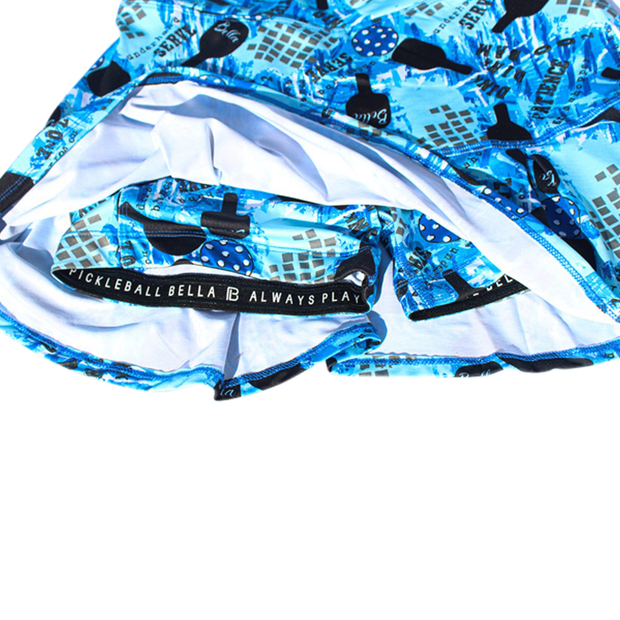 Blue graffiti print drop pleat skort by Pickleball Bella, with inner shorts and waistband displaying 'PICKLEBALL BELLA ALWAYS PLAY'.