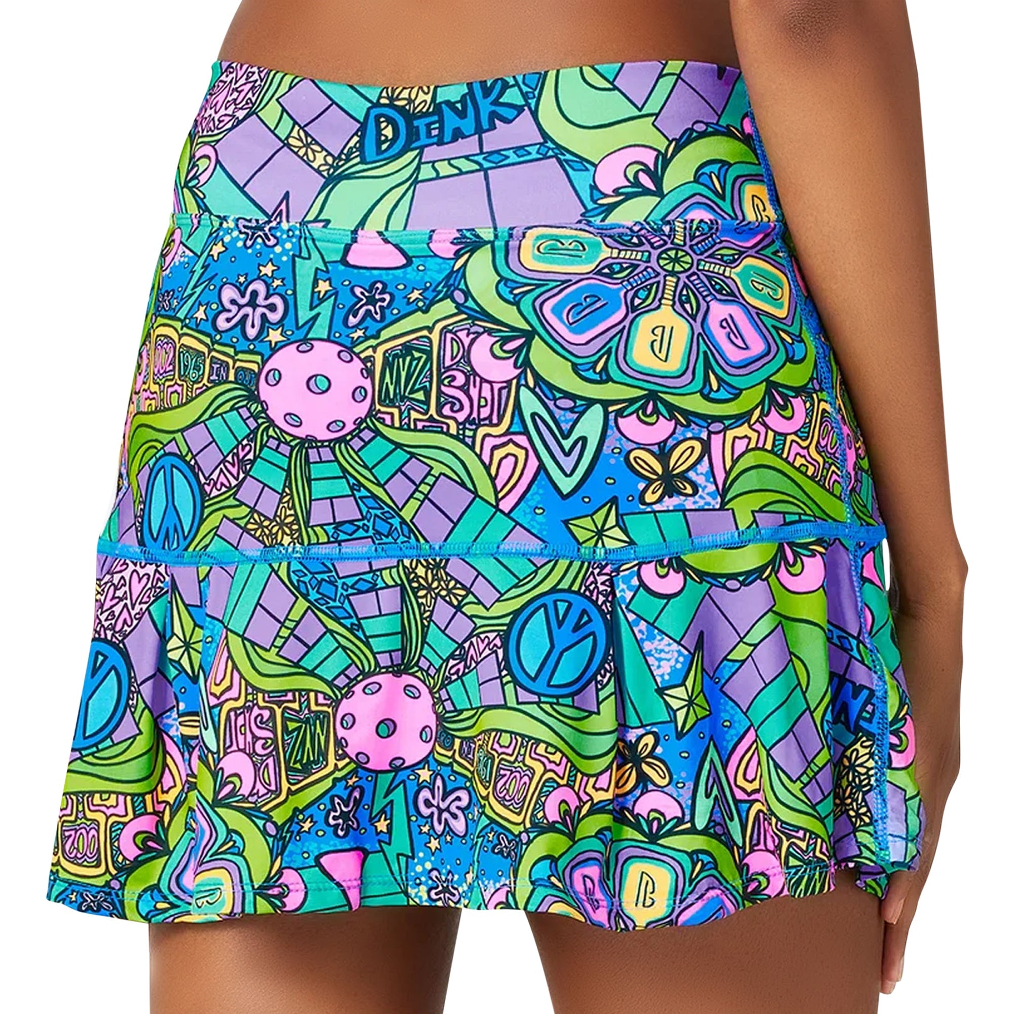 Groovy patterned pleat skort by Pickleball Bella, with peace signs, pickleball balls, and DINK lettering, shown from the back.
