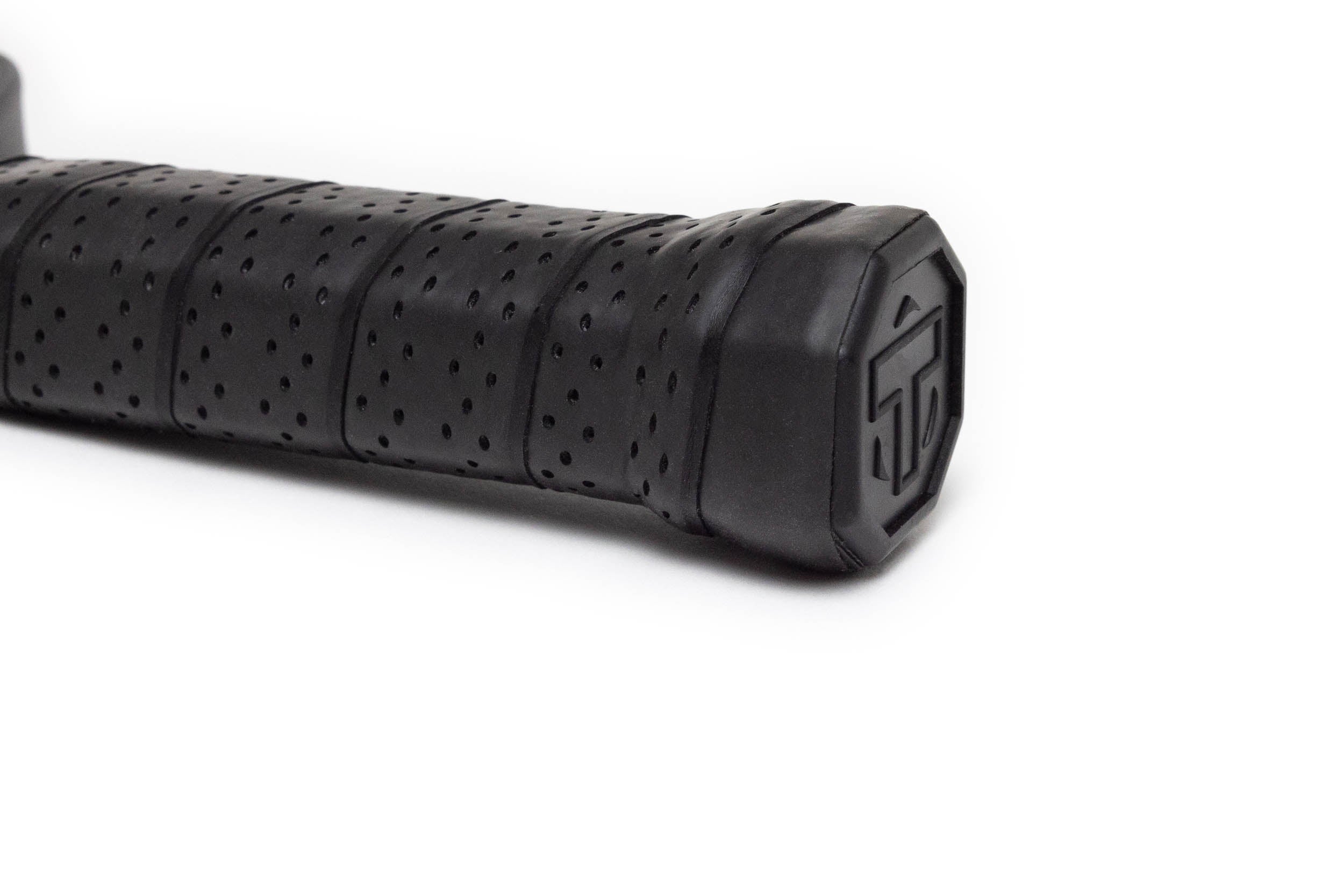 Black perforated grip for a pickleball paddle by TMPR Sports, featuring a ribbed texture and end cap logo.