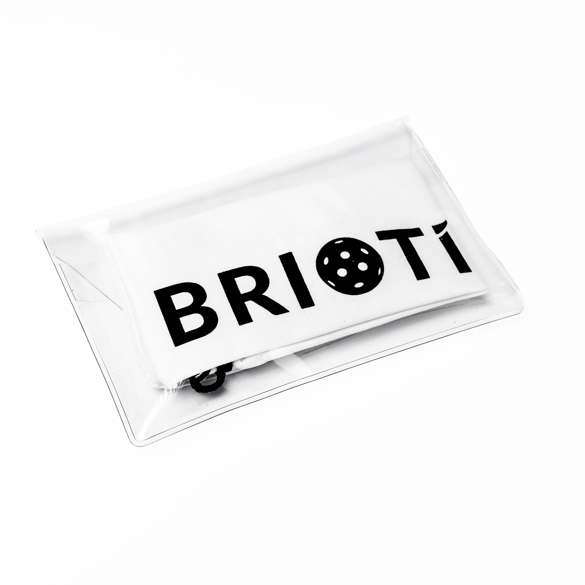 Product shot of a white towel inside a clear plastic pouch. The towel has the brand name "BRIOTi" printed in black.