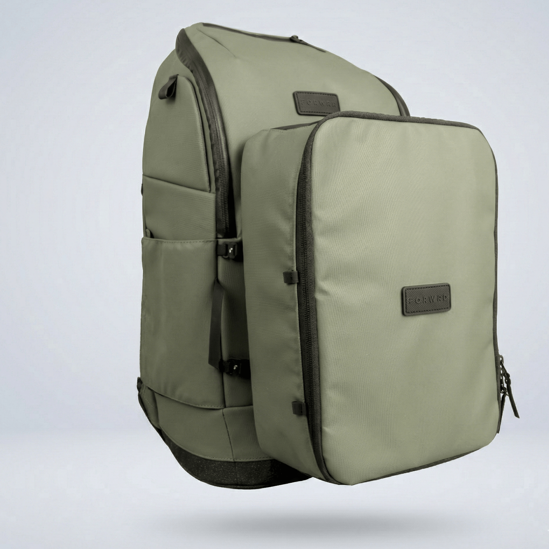 Olive green shoe cube by FORWRD, textured fabric with a dark zipper and logo label, floating beside a coordinating backpack.