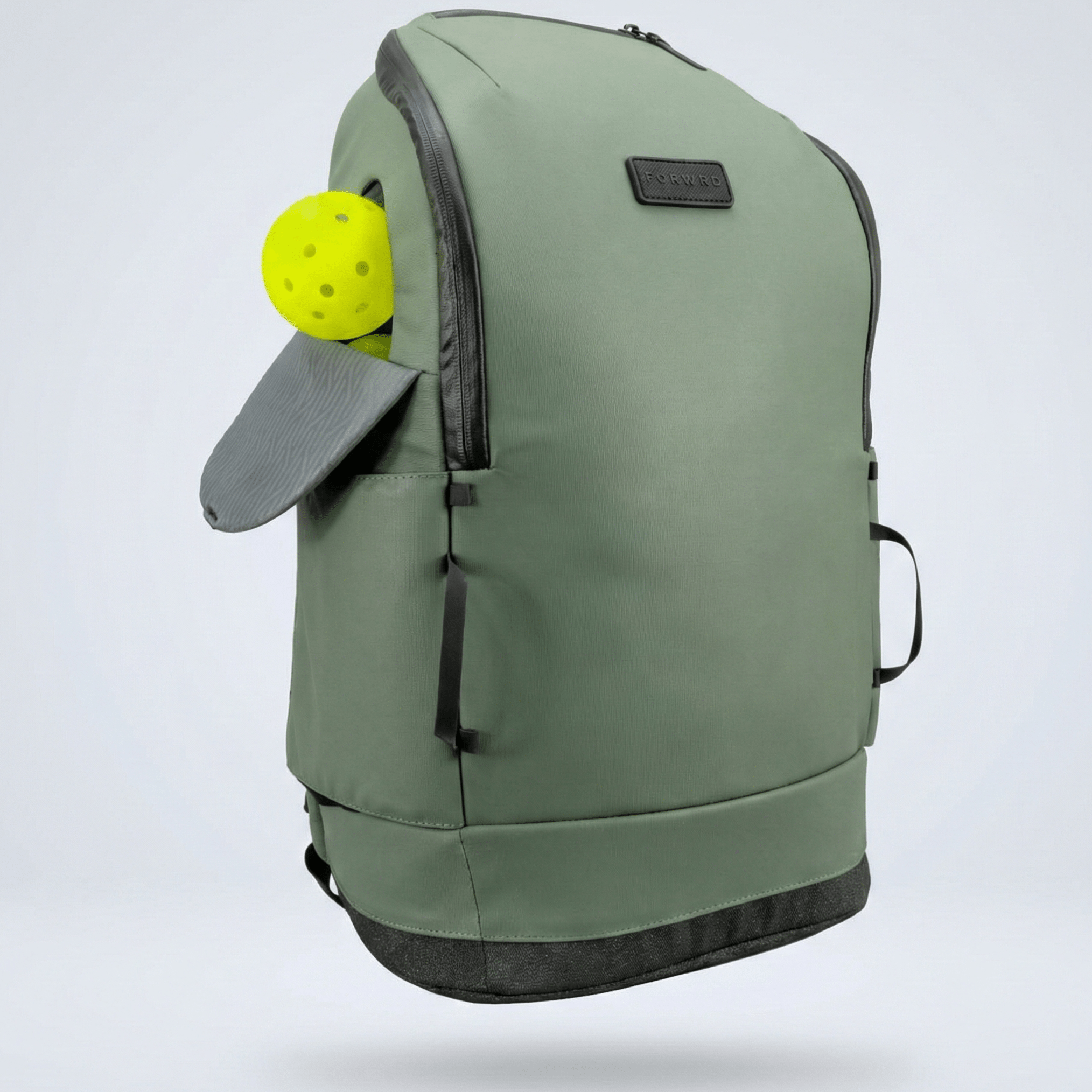 Sage green pickleball backpack by FORWRD, with an open pocket showing a yellow pickleball and a textured gray flap.