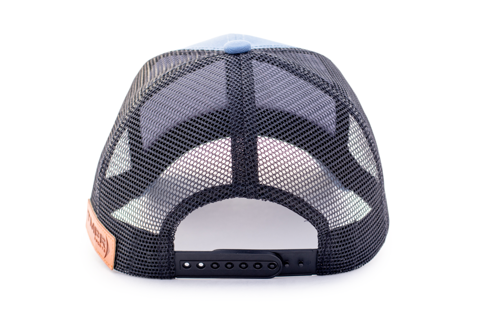 Light blue and black mesh Trucker Cap by TMPR Sports, shown from the back with a black snapback closure and a brown leather patch.