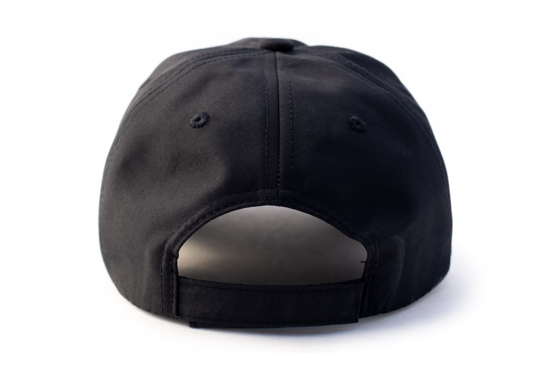 Black performance cap by TMPR Sports, shown from the back with eyelets and an adjustable strap.