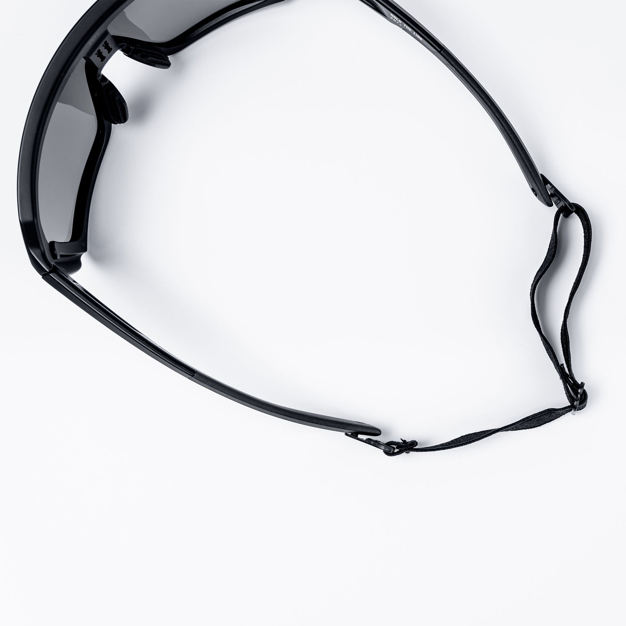 Sunglasses with black frame and strap on white background.