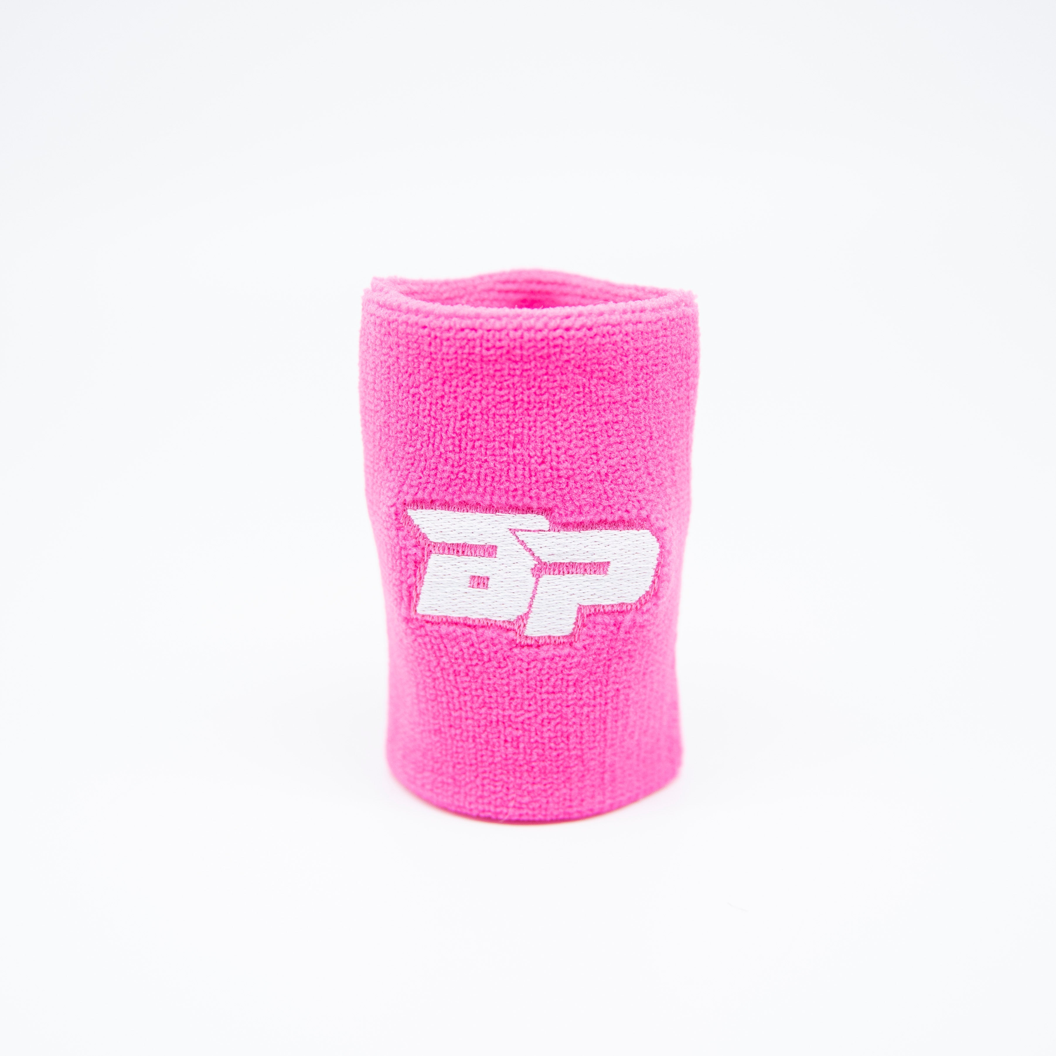 Close-up of a pink wristband with white lettering.