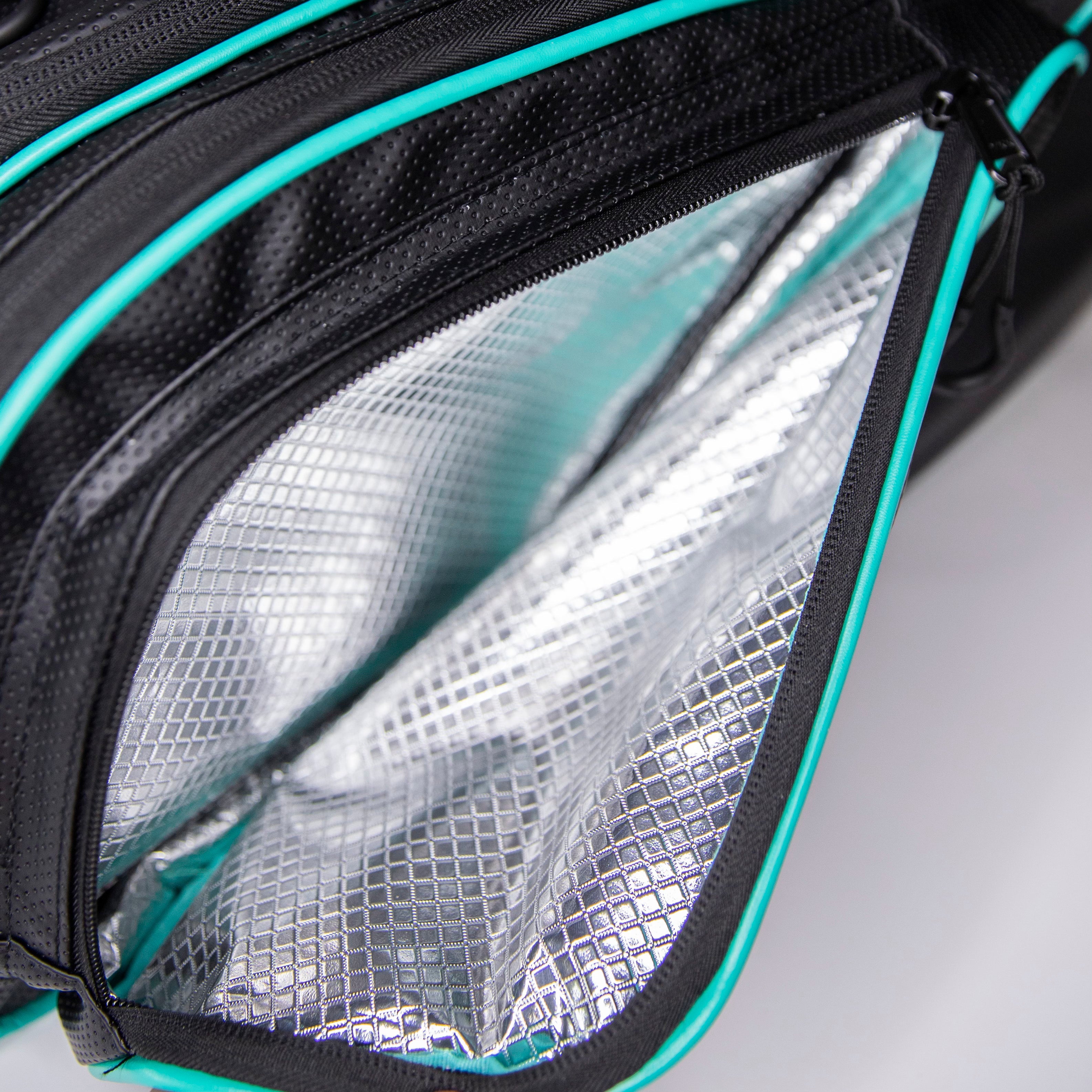 Open insulated black bag with turquoise trim.