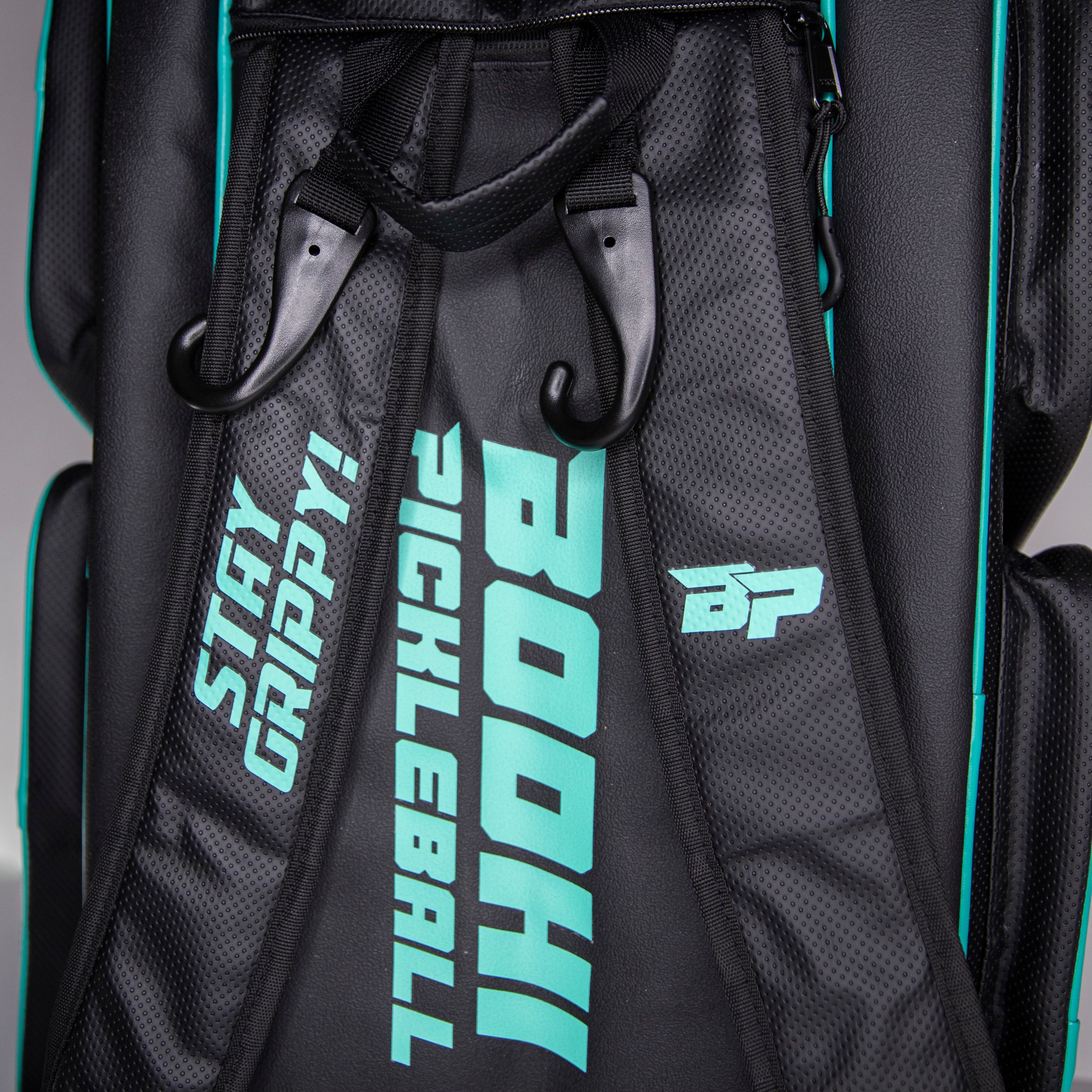 Close-up of a black and teal pickleball bag.